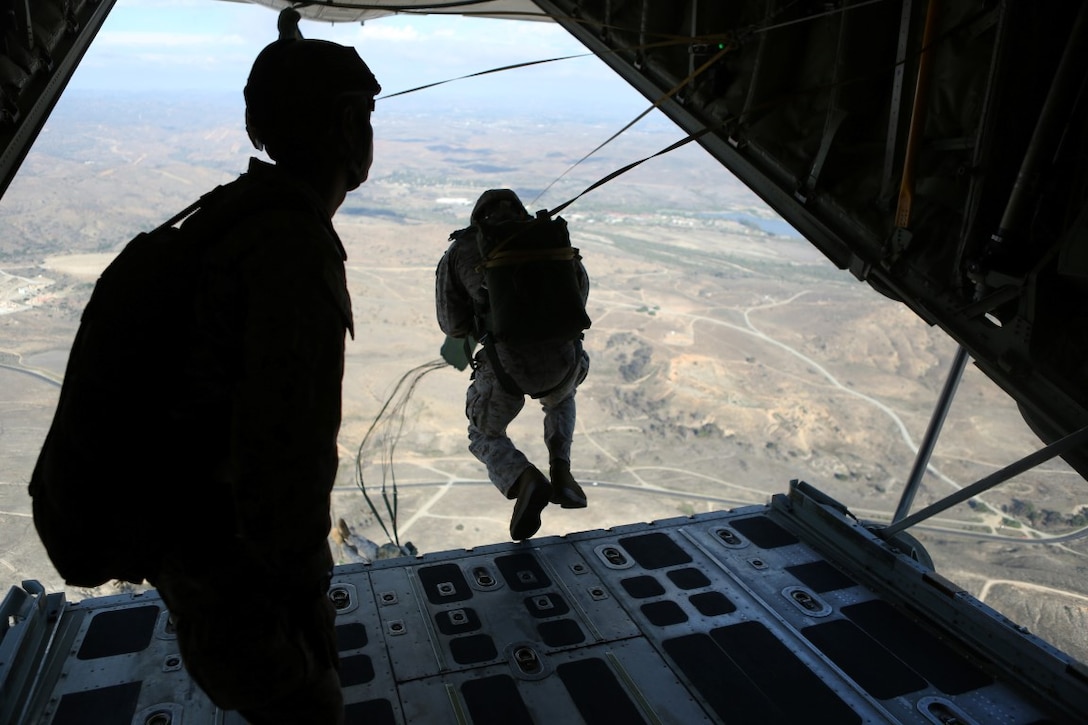 Marines with 1st Reconnaissance Battalion, 1st Marine Division conduct static-line parachute operations from a C-130 Hercules with 3rd Marine Aircraft Wing aboard Marine Corps Base Camp Pendleton, Calif., Oct. 16, 2015. 1st Recon conducted parachute operations in preparation for future deployments. (U.S. Marine Corps photo by Cpl. Demetrius Morgan/RELEASED)