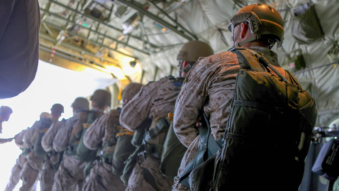 Marines with 1st Reconnaissance Battalion, 1st Marine Division conduct drills inside of a C-130 Hercules with 3rd Marine Aircraft Wing prior to static-line parachute operations and free fall jump training aboard Marine Corps Base Camp Pendleton, Calif., Oct. 16, 2015. 1st Recon conducted parachute operations in preparation for future deployments. 