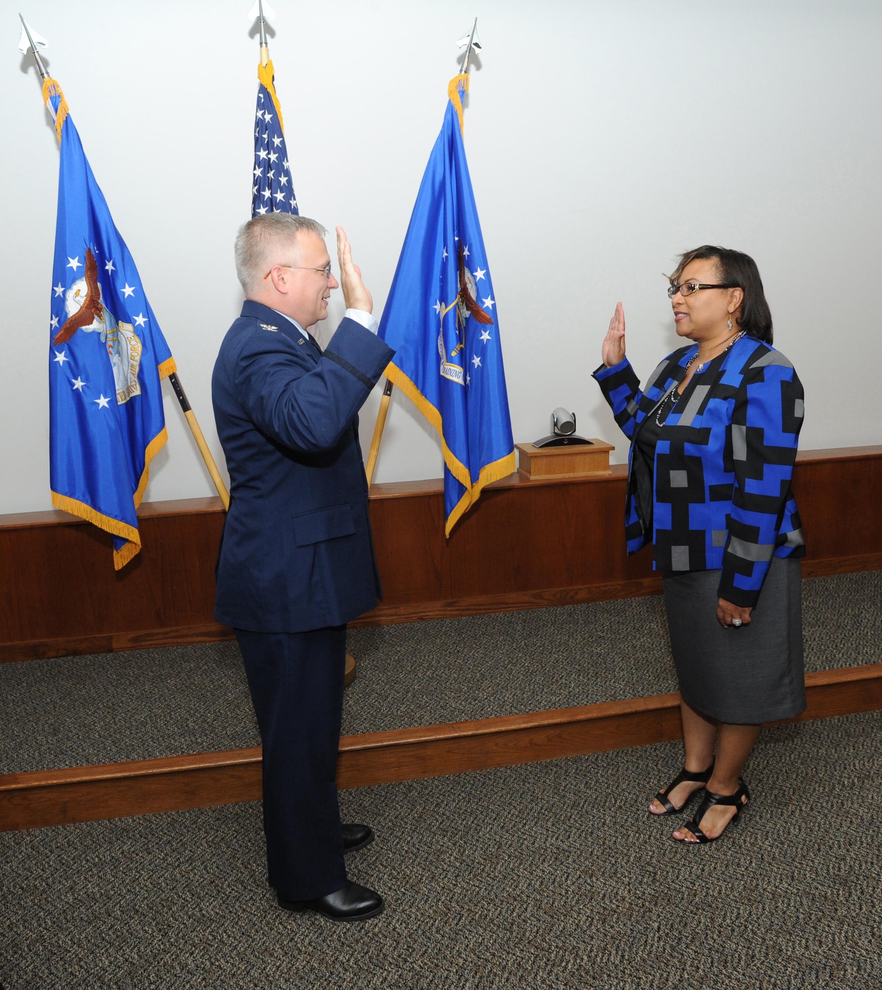 Col. Joe Rizzuto, Profession of Arms Center of Excellence director, reaffirms the Oath of Office during Ms. Quency Henson, PACE professionalism training manager, promotion ceremony Oct. 18, 2015 at Joint Base San Antonio-Randolph. 