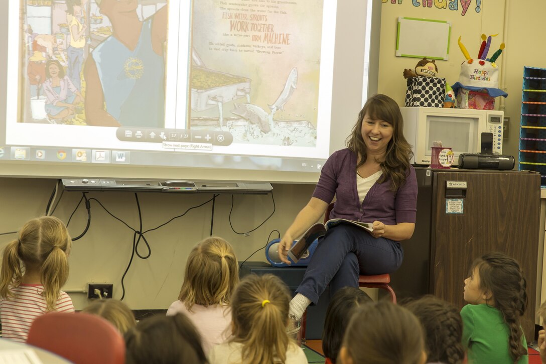 Stephanie Johnson, a 1st grade teacher with Matthew C. Perry Elementary, reads to her students as part of an official attempt to break a Guinness World Record aimed to raise awareness about literacy at Marine Corps Air Station Iwakuni, Japan, Oct. 19, 2015. By working across time zones and continents, Points of Light, the Barbara Bush Houston Literacy Foundation, Deloitte and hundreds of other organizations hope to read to the most children ever in a 24 hour period. Read Across the Globe is an event during this literacy-awareness week that brings the power of volunteers together to impact literacy in local communities. This is the first time M.C. Perry Elementary participated in Read Across the Globe and Landrum said even if the record is not broken, the students and facility enjoyed a great day of reading.