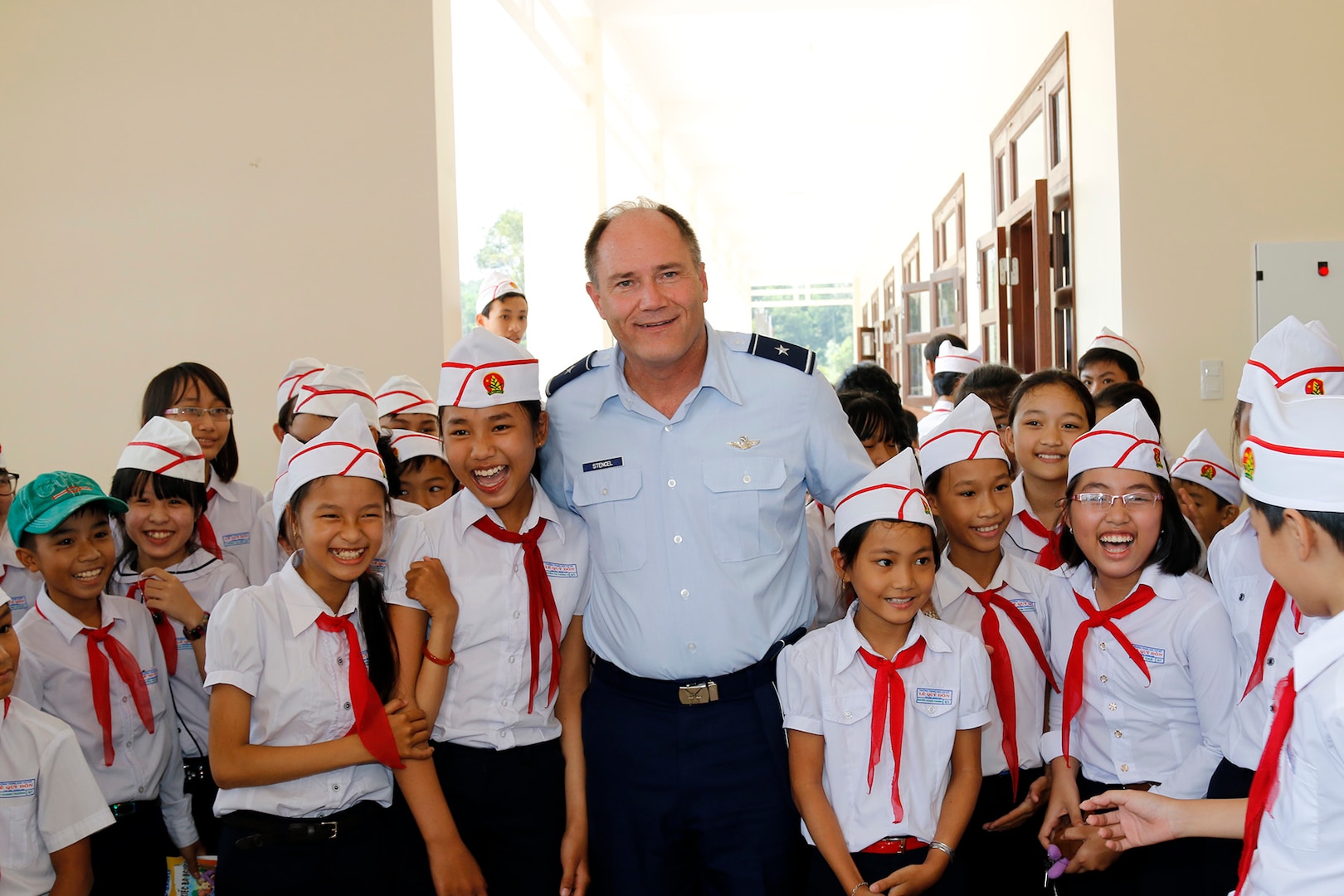 Brig. Gen. Michael E. Stencel, Adjutant General, Oregon, poses for a photo with students at their new intermediate school in Phu Tinh Village in the Quang Nam Province of Vietnam, Oct. 21, following a ribbon cutting ceremony. The new school was built in cooperation between the U.S. and Vietnam and has a secondary-use as a shelter during natural disasters.