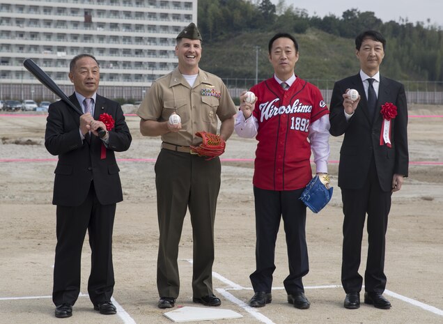 Toshiyuki Kuwahara, chairman of Iwakuni City Assembly, Col. Robert V. Boucher, commanding officer of Marine Corps Air Station Iwakuni, Yoshihiko Fukuda, mayor of Iwakuni City, and Takahiro Sugawara, director general of Chugoku-Shikoku Defense Bureau, pose for a picture after the first pitch at the ground breaking ceremony of Atagoyama Baseball Field in Iwakuni City, Japan, Oct. 15, 2015. Atagoyama provided the dirt and sand used in constructing a new runway on MCAS Iwakuni. The ground breaking ceremony represented the construction of the baseball field and future U.S. – Japan relationships.