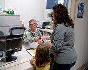 Tech. Sgt. Jason Hanafin, 90th Medical Operations Squadron Immunization Office, schedules a flu vaccination Oct. 20, 2015, in the 90th Medical Group Immunization Office. Airman, retirees and dependents are eligible to be vaccinated. (U.S. Air Force photo by Airman 1st Class Malcolm Mayfield)