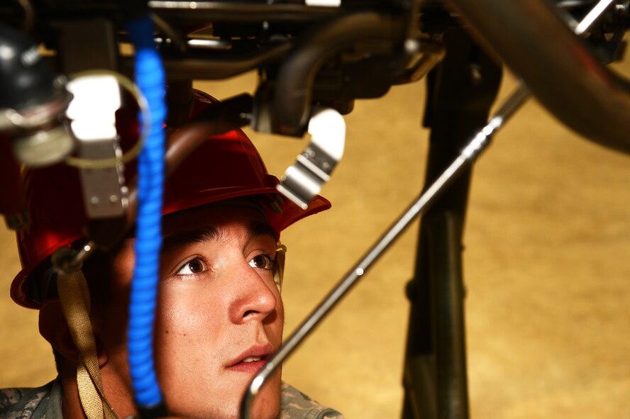 U.S. Air Force Airman Nicholas Trugilo, 372nd Training Squadron, Detachment 202 student, observes as a classmate tightens a bolt on an F-16 Fighting Falcon engine at Shaw Air Force Base, S.C., Oct. 22, 2015. Det. 202 conducts upgrade training for F-16 maintainers in multiple Air Force Specialty Codes to increase their ability and knowledge of the assigned aircraft. (U.S. Air Force photo by Senior Airman Jonathan Bass/Released)
