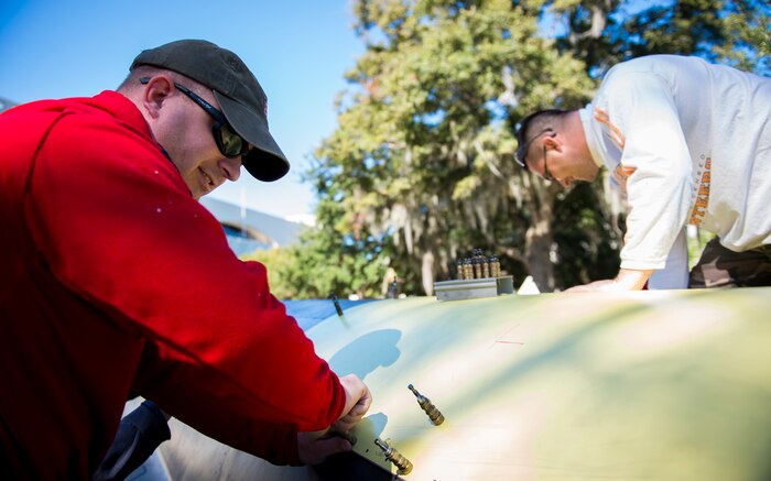 Tech. Sgt. Andrew Finley, 437th Maintenance Squadron sheet metal technician, adjusts the sheet metal of an F-4 Phantom II Oct. 18, 2015, on the parade grounds at the Citadel in Charleston, S.C. During the recent storms that impacted the east coast, trees damaged static aircraft. Parts of the wing, underwing and fuselage were severely compromised. The 437th AMXS volunteered weekends to assist the Citadel in repairing the aircraft. (U.S. Air Force photo/Airman 1st Class Clayton Cupit)