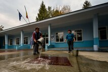 Teachers from Liceul Teoretic Alexei Mateevici School, wash a rug Oct. 19, 2015, in Sanatauca, Moldova.   Approximately seven Airmen from the 435th Construction and Training Squadron and the 52nd Civil Engineer Squadron worked on the renovations since Sept. 23. The renovations were part of the Moldova Humanitarian and Civic Assistance program is part of a military and civilian theater security cooperation program the U.S. European Command uses to directly impact civilian communities throughout 17 countries, primarily in Eastern Europe. (U.S. Air Force photo/Senior Airman Nicole Sikorski)