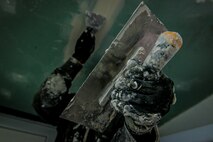 Staff Sgt. Altes Durand, 435th Construction and Training Squadron NCO in charge of heating, cool, ventilation and air conditioning, applies spackle paste to a ceiling Oct. 18, 2015, at Liceul Teoretic Alexei Mateevici School, Sanatauca, Moldova. Approximately seven Airmen from the 435th CTS and the 52nd Civil Engineer Squadron worked on the renovations since Sept. 23. The renovations were part of the Moldova Humanitarian and Civic Assistance program is part of a military and civilian theater security cooperation program the U.S. European Command uses to directly impact civilian communities throughout 17 countries, primarily in Eastern Europe.(U.S. Air Force photo/Senior Airman Nicole Sikorski)