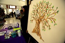 Members assigned to the 36th Medical Operations Squadron Family Advocacy Program hosted a domestic violence prevention information booth Oct. 8, 2015, at Andersen Air Force Base, Guam. Service members and their families were encouraged to take a pledge to live by the Air Force core values and prevent domestic abuse. (U.S. Air Force photo by Airman 1st Class Alexa Ann Henderson/Released)