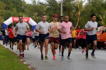 Airmen participate in the Pink 5K run Oct. 21, 2015, at Tarague Beach on Andersen Air Force Base, Guam. More than 100 people attended the run to raise awareness about breast cancer. (U.S. Air Force photo by Airman 1st Class Alexa Ann Henderson/Released)