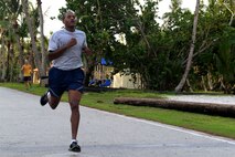 A runner sprints the last yards of the Pink 5K run Oct. 21, 2015, at Andersen Air Force Base, Guam. More than 100 people attended the run to raise awareness about breast cancer. (U.S. Air Force photo by Airman 1st Class Alexa Ann Henderson/Released)