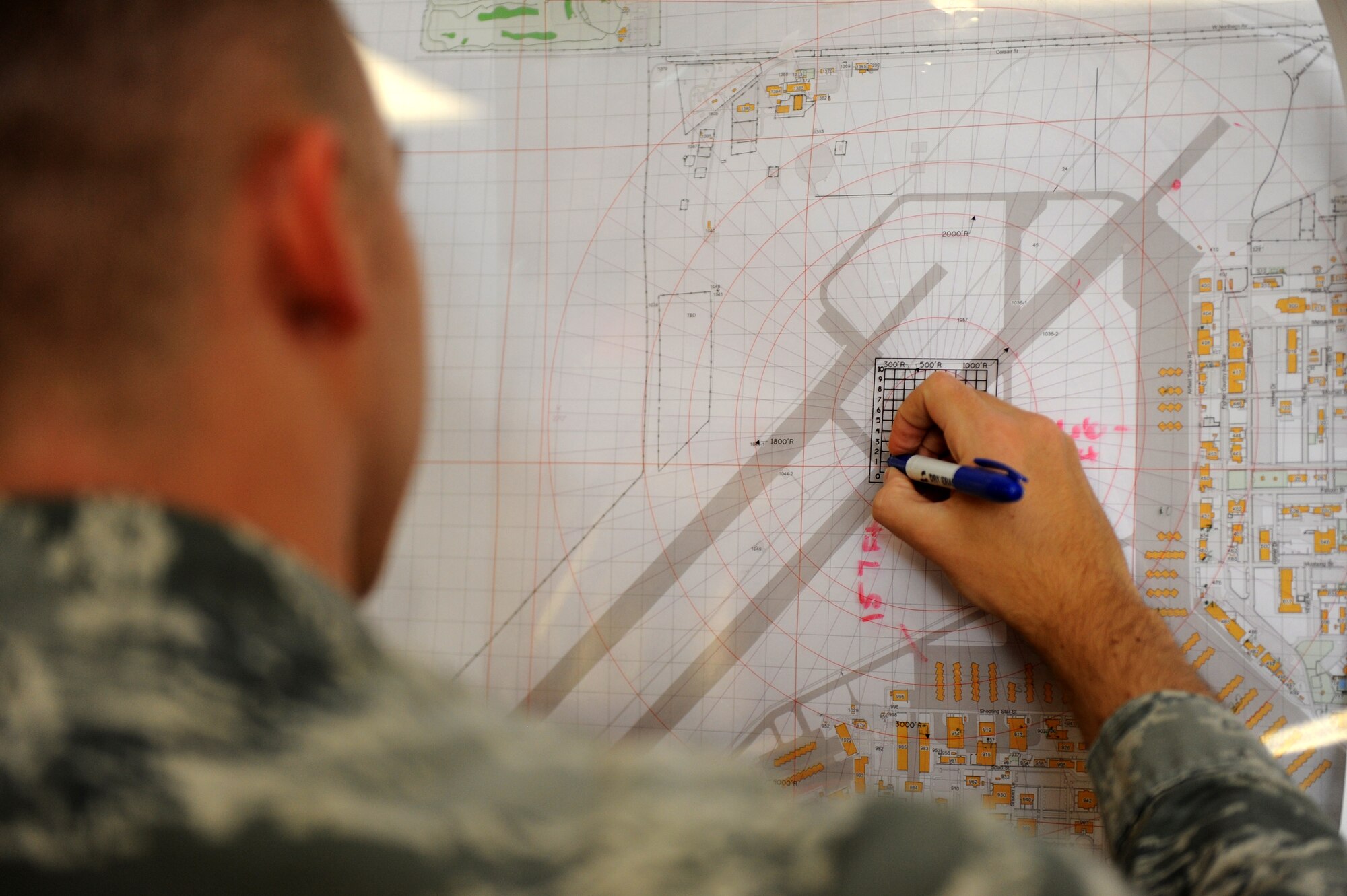 Senior Airman Jordan Stoltz, 56th Operations Support Squadron airfield management shift lead, maps a point on a Luke Air Force Base map Oct 13 2015. Airfield management is responsible for ground and flight safety ensuring the wellbeing of pilots at Luke Air Force Base. (U.S. Air Force photo by Staff Sgt. Staci Miller)