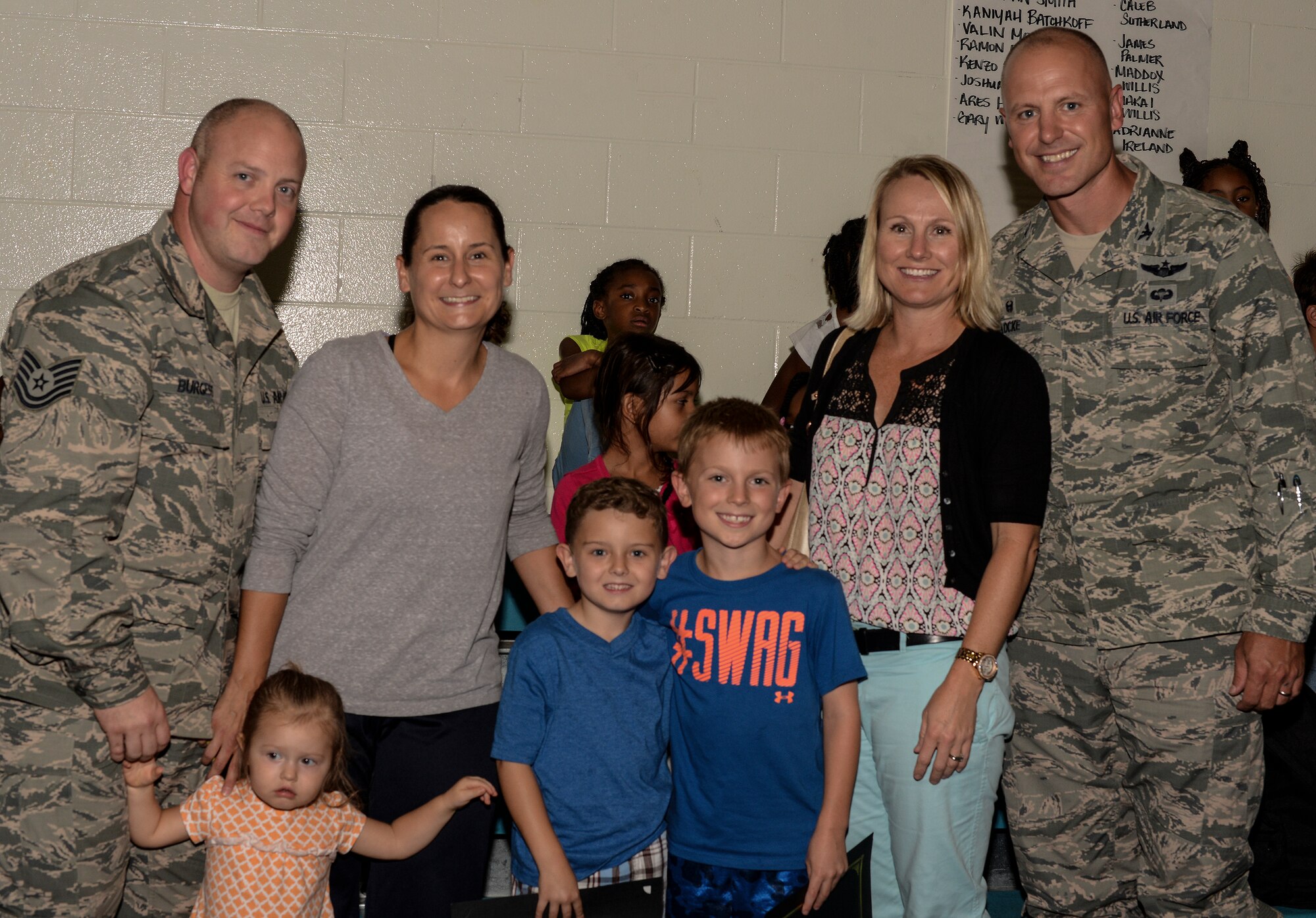 The Burgess and Locke families pose for a portrait during an award ceremony for Quinn, son of U.S. Air Force Tech Sgt. Daniel Burgess, 41st Helicopter Maintenance Unit, and Garrett Locke, son of Col. Joseph Locke, 93d Air Ground Operations Wing commander, September 9, 2015, at Moody Air Force Base Ga. Quinn, Garrett, and Devinn Dunn, son of retired Master Sgt. James Dunn, danced their way to first place in the Moody Talent Search and second place in the Air Force wide Operation Talent Search. (U.S. Air Force photo by Airman 1st Class Janiqua P. Robinson/Released)
