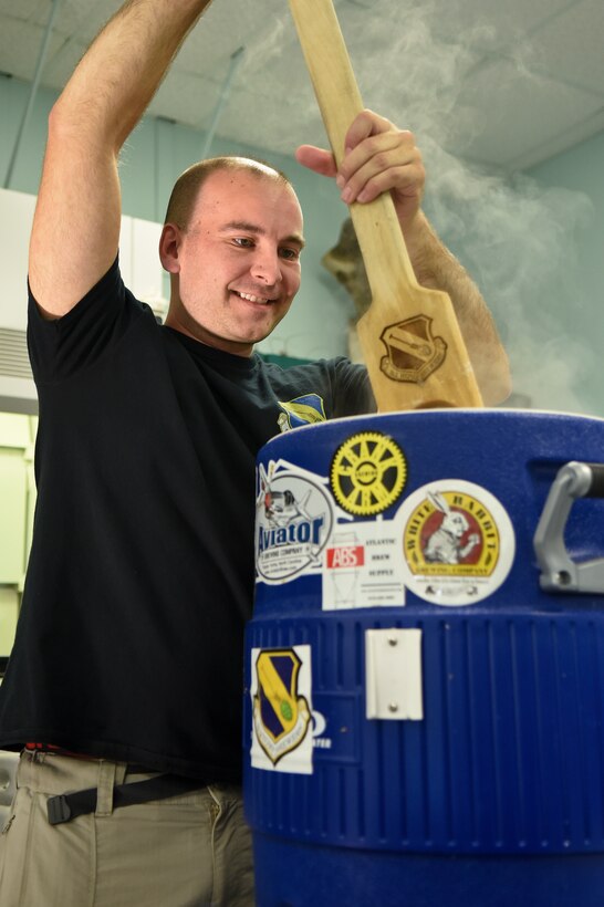 First Lt. Ryan DeLine, 4th Equipment Maintenance Squadron maintenance flight commander, stirs grains steeping in hot water during a brewing workshop Oct. 17, 2015, at Wayne Community College in Goldsboro, North Carolina. DeLine, a member of the Seymour Johnson Home Brew Club was invited to teach all-grain brewing techniques at the event in addition to normal curriculum, which only teaches the extract method. (U.S. Air Force photo/Senior Airman Aaron J. Jenne)