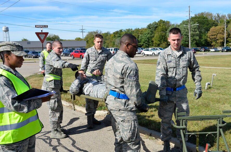 WRIGHT-PATTERSON AIR FORCE BASE, Ohio – 445th Aeromedical Staging Squadron medical technicians evacuate a patient to a shelter during the ASTS “Victory or Death – Heal and Defend” exercise Oct. 4, 2015. Approximately 70 Airmen participated in the 24-event exercise designed to accomplish annual and quarterly mandatory and ancillary training. (U.S. Air Force photo/Senior Airman Joel McCullough)