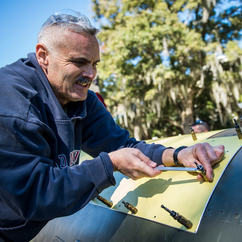 Senior Master Sgt. Eric McKenzie, 437th Maintenance Squadron fabrication flight chief, adjusts the sheet metal of an F-4 Phantom II Oct. 18, 2015, on the parade grounds at the Citadel in Charleston, S.C. During the recent storms that impacted the east coast, trees damaged the static aircraft. Parts of the wing, underwing and fuselage were severely compromised. The 437th AMXS volunteered weekends to assist the Citadel in repairing the aircraft. (U.S. Air Force photo/Airman 1st Class Clayton Cupit)