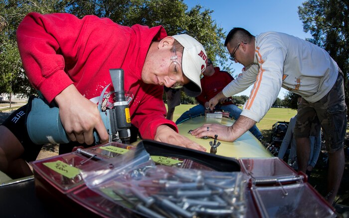 Airman 1st Class Mitchell Bergmann, 437th Maintenance Squadron sheet metal technician, drills sheet metal into an F-4 Phantom II for repairs Oct. 18, 2015, on the parade grounds at The Citadel in Charleston, S.C. During the recent storms that impacted the east coast, trees damaged the static aircraft. Parts of the wing, underwing and fuselage were severely compromised. The 437th AMXS volunteered weekends to assist the Citadel in repairing the aircraft. (U.S. Air Force photo/Airman 1st Class Clayton Cupit)