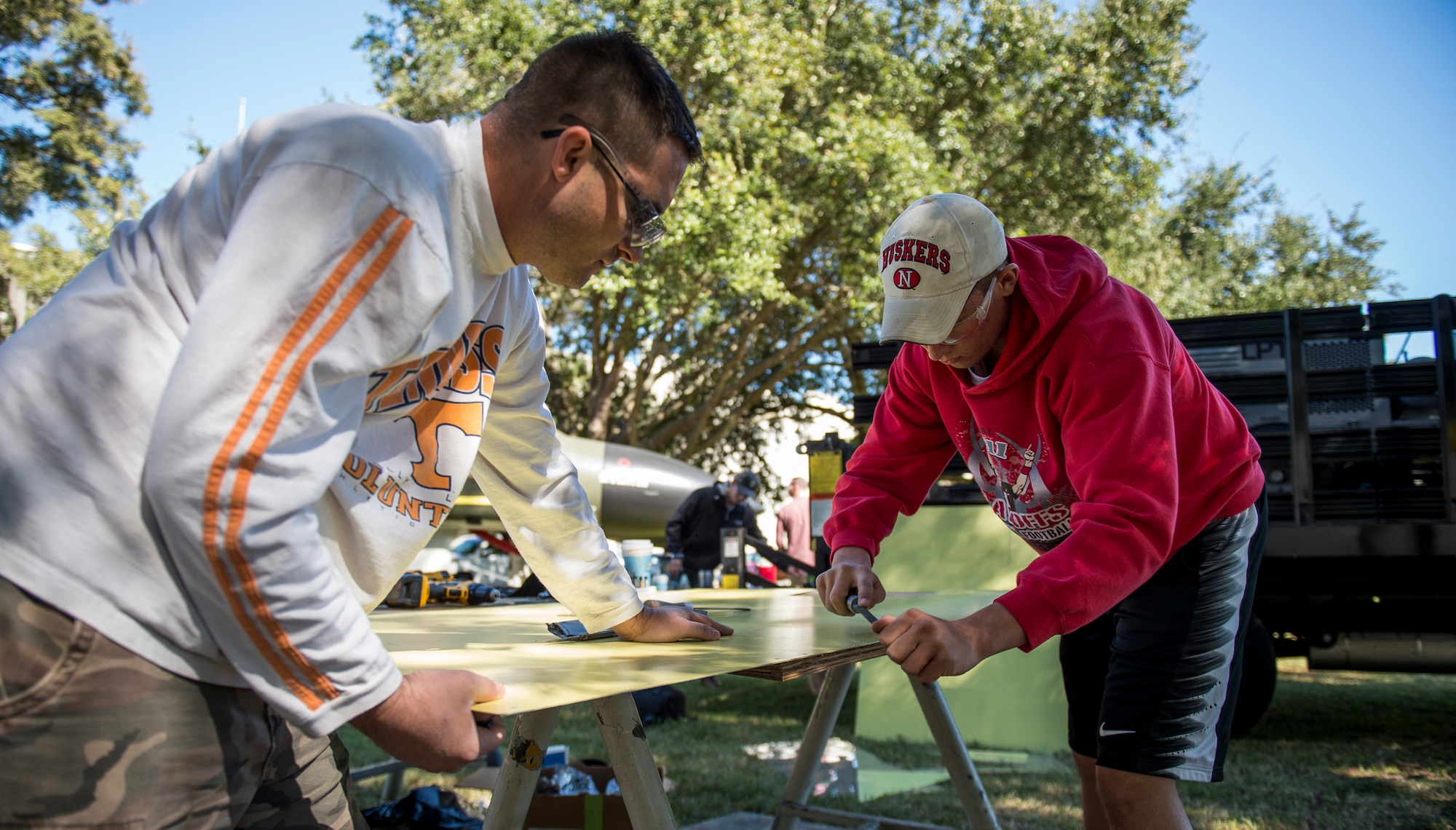 Tech. Sgt. James Hurst, 437th Maintenance Squadron aircraft structural maintenance section chief and Airman 1st Class Mitchell Bergmann, 437th MXS sheet metal technician, prepare metal to be used for repairs on an F-4 Phantom II Oct. 18, 2015, located on the parade grounds of the Citadel in Charleston, S.C. During the recent storms that impacted the east coast, trees damaged the static aircraft. Parts of the wing, underwing and fuselage were severely compromised. The 437th AMXS volunteered on weekends to assist the Citadel in repairing the aircraft. (U.S. Air Force photo/Airman 1st Class Clayton Cupit)