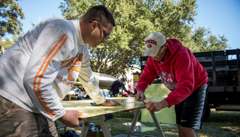 Tech. Sgt. James Hurst, 437th Maintenance Squadron aircraft structural maintenance section chief and Airman 1st Class Mitchell Bergmann, 437th MXS sheet metal technician, prepare metal to be used for repairs on an F-4 Phantom II Oct. 18, 2015, located on the parade grounds of the Citadel in Charleston, S.C. During the recent storms that impacted the east coast, trees damaged the static aircraft. Parts of the wing, underwing and fuselage were severely compromised. The 437th AMXS volunteered on weekends to assist the Citadel in repairing the aircraft. (U.S. Air Force photo/Airman 1st Class Clayton Cupit)