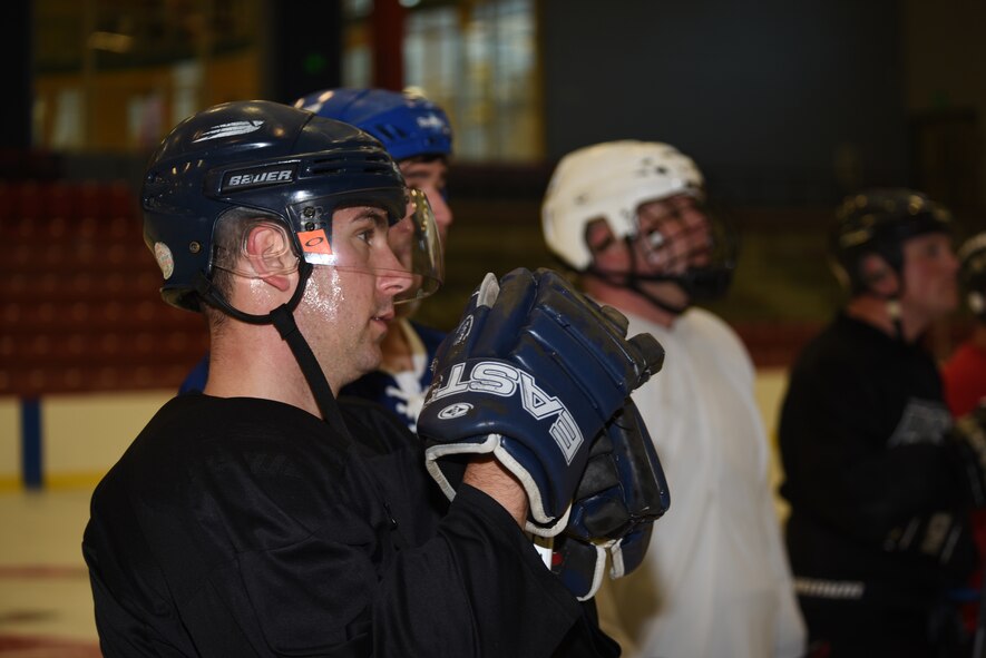 Staff Sgt. DJ Fandel, 92nd Security Forces Squadron patrolman, listens as the head coach explains what they will be doing during practice Sept. 30, 2015, at Eastern Washington University, Wash. The Fairchild Falcons draw players from active duty, guard, civilians, retirees and dependents to create a fully integrated team. (U.S. Air Force photo/Airman 1st Class Sean Campbell)