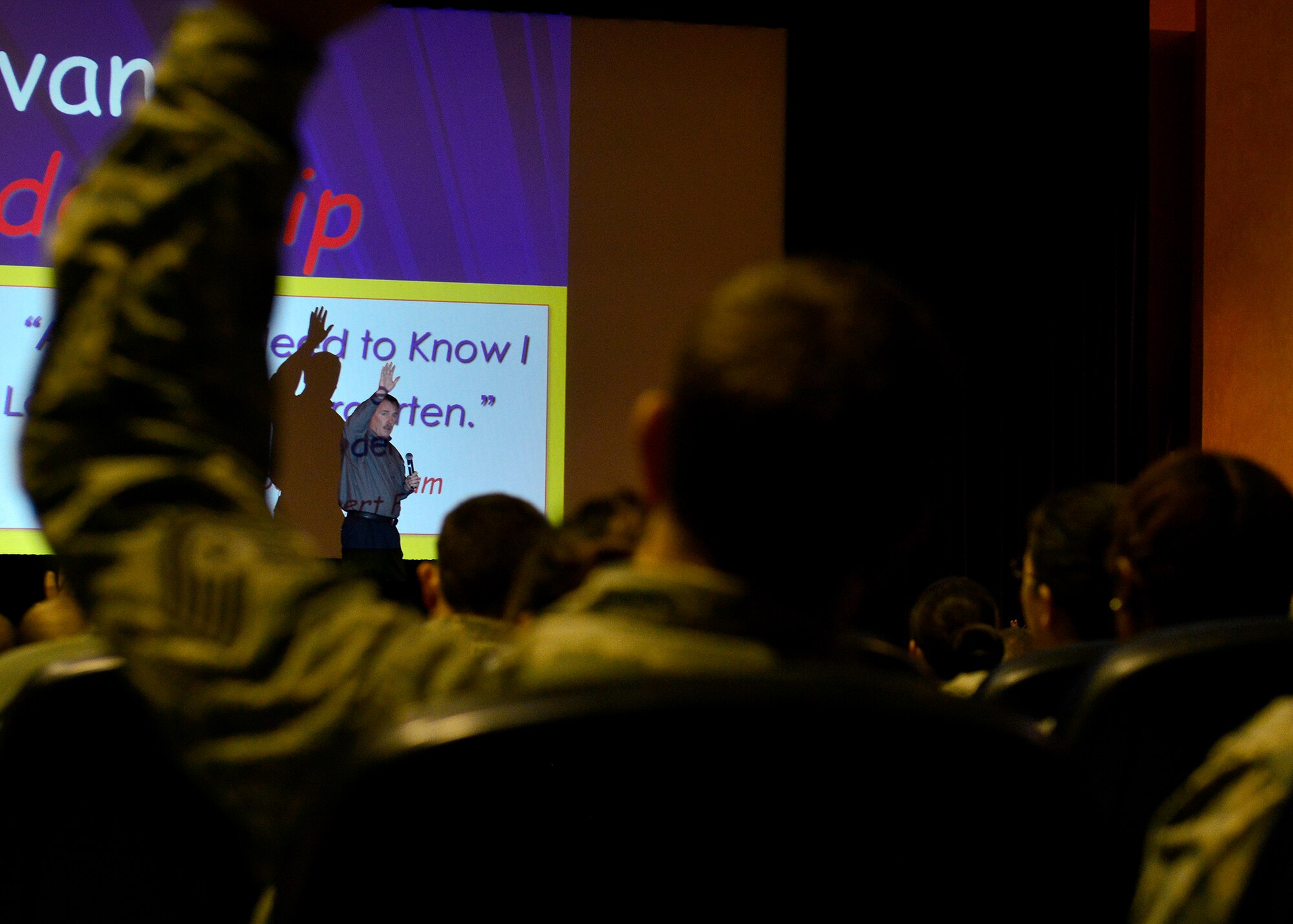 Jim Hunter, author and public speaker, asks the audience a question during a servant leadership seminar, Oct. 20, 2015, at Aviano Air Base, Italy. Topics during the seminars included the qualities that make up a servant leader and how all Airmen can develop their leadership style. (U.S. Air Force photo by Airman 1st Cary Smith/Released)