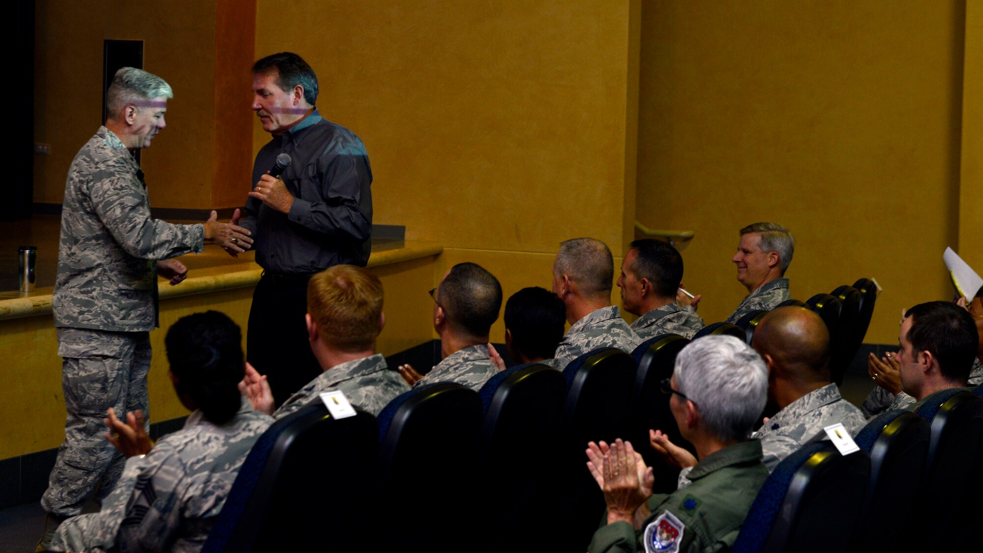 Gen. Barre Seguin, 31st Fighter Wing commander, shakes Jim Hunter’s, author and public speaker, hand at a servant leadership seminar, Oct. 20, 2015, at Aviano Air Base, Italy. Two seminars provided valuable information on servant leadership to help build high-performance teamwork and future leaders. (U.S. Air Force photo by Airman 1st Cary Smith/Released)