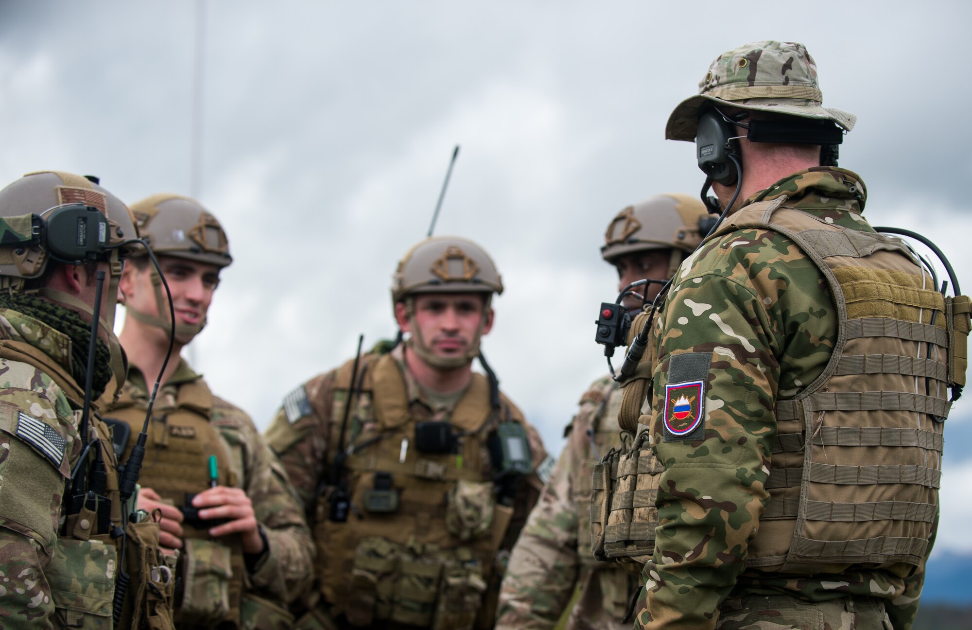 Joint terminal attack controllers from the U.S. and Slovenian militaries discuss a bombing run by a Slovenian PC-9M Hudournik aircraft, during exercise Rock Proof V Oct. 16, 2015, at Pocek Training Range, near Postojna, Slovenia. The JTACs joined U.S. Soldiers from the 2nd Battalion, 503rd Infantry Regiment to provide close air support during the live-fire training. (U.S. Air Force photo/ Staff Sgt. Armando A. Schwier-Morales)