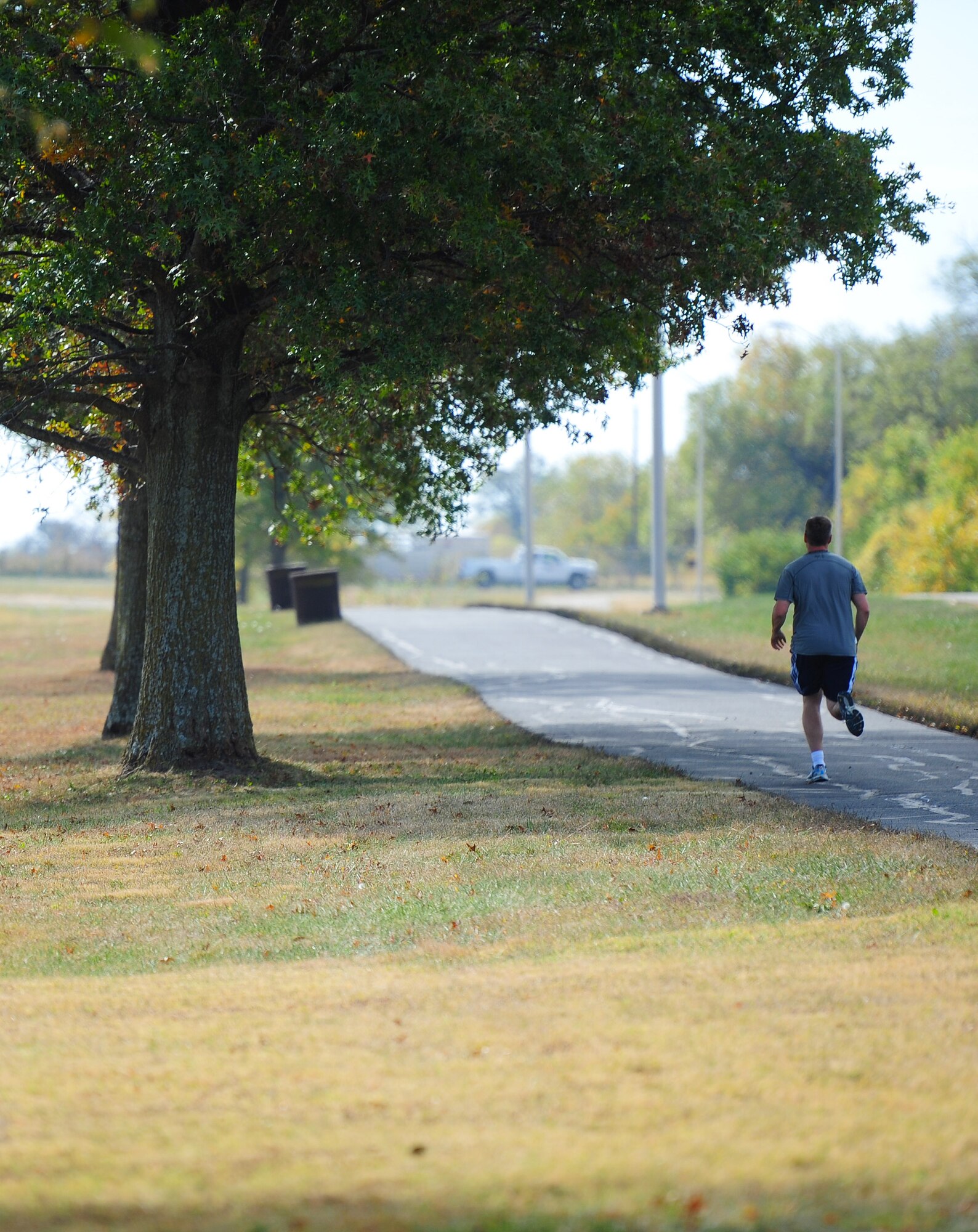 Lt. Col. Tim Rezac, 131st Bomb Wing chief of safety, runs on the jogging path surrounding Ike Skelton Lake Oct. 21, 2015, at Whiteman Air Force Base, Mo. The path is currently closed for repairs, to include joint and surface sealing, and is scheduled to reopen at the end of the month. (U.S. Air Force photo by Airman 1st Class Jazmin Smith/Released)