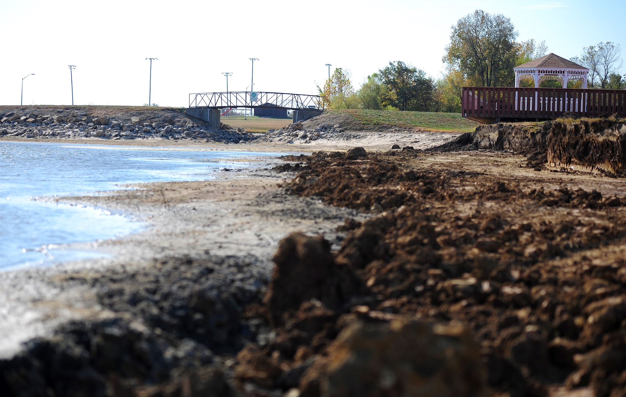 The shoreline at Ike Skelton Lake is exposed Oct. 20, 2015, following a draining performed by contractors at Whiteman Air Force Base, Mo. The water level was lowered as part of an on-going project which includes the installation of a brick wall along the water’s edge. Following the shoreline reinforcement, the water level will be raised higher than normal, which decreases the algae and weed growth in the shallow areas of the pond. The shoreline is scheduled to be closed until December 2015. (U.S. Air Force photo by Airman 1st Class Jazmin Smith/Released)