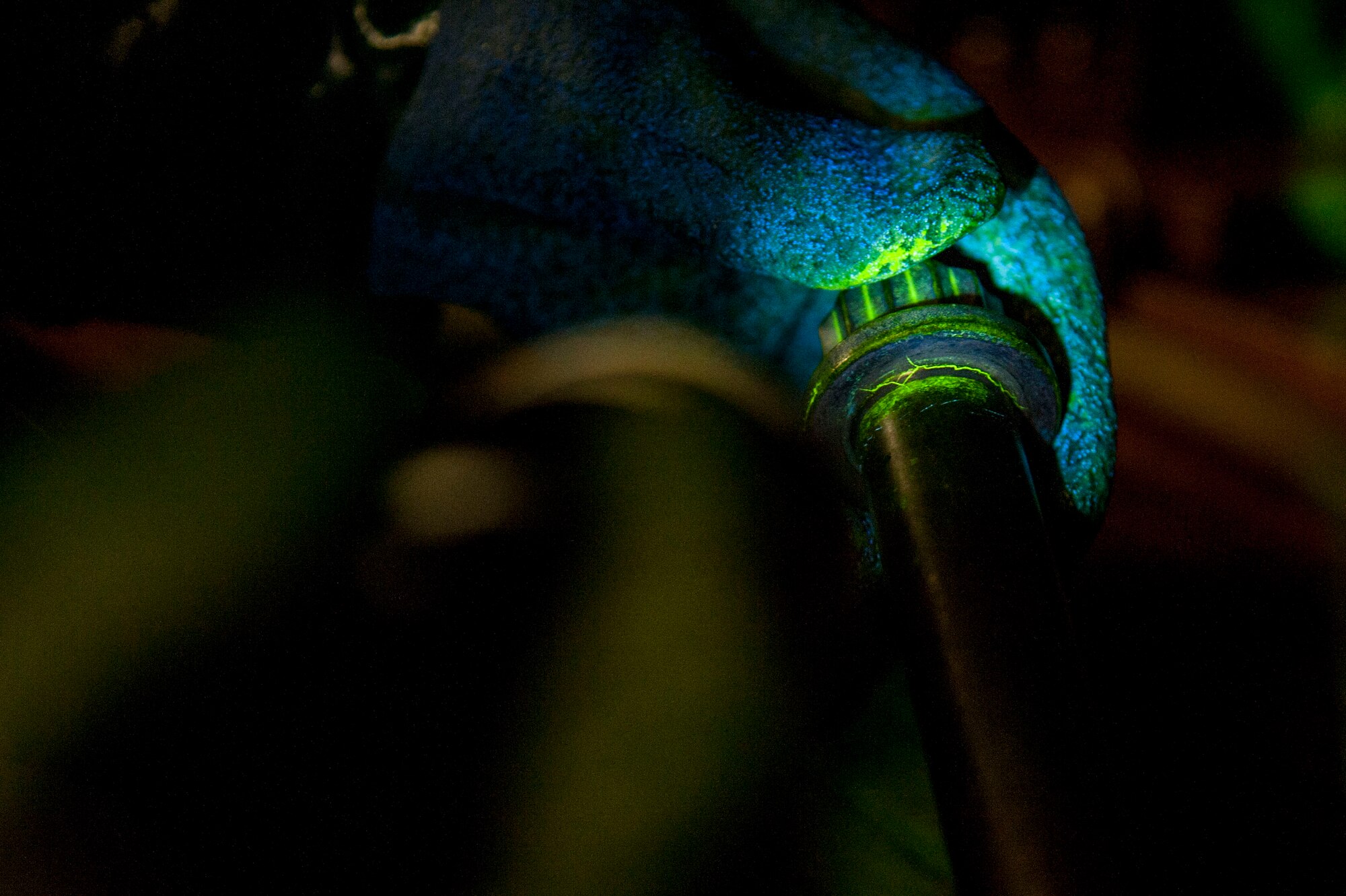 A fault, highlighted in neon yellow, is identified and found in an aircraft part Oct. 14, 2015, on Little Rock Air Force Base, Ark. Non-destructive inspection Airmen run aircraft components under a variety of chemical baths to find tiny cracks that could cause major accidents. (U.S. Air Force photo by Airman 1st Class Mercedes Muro) 