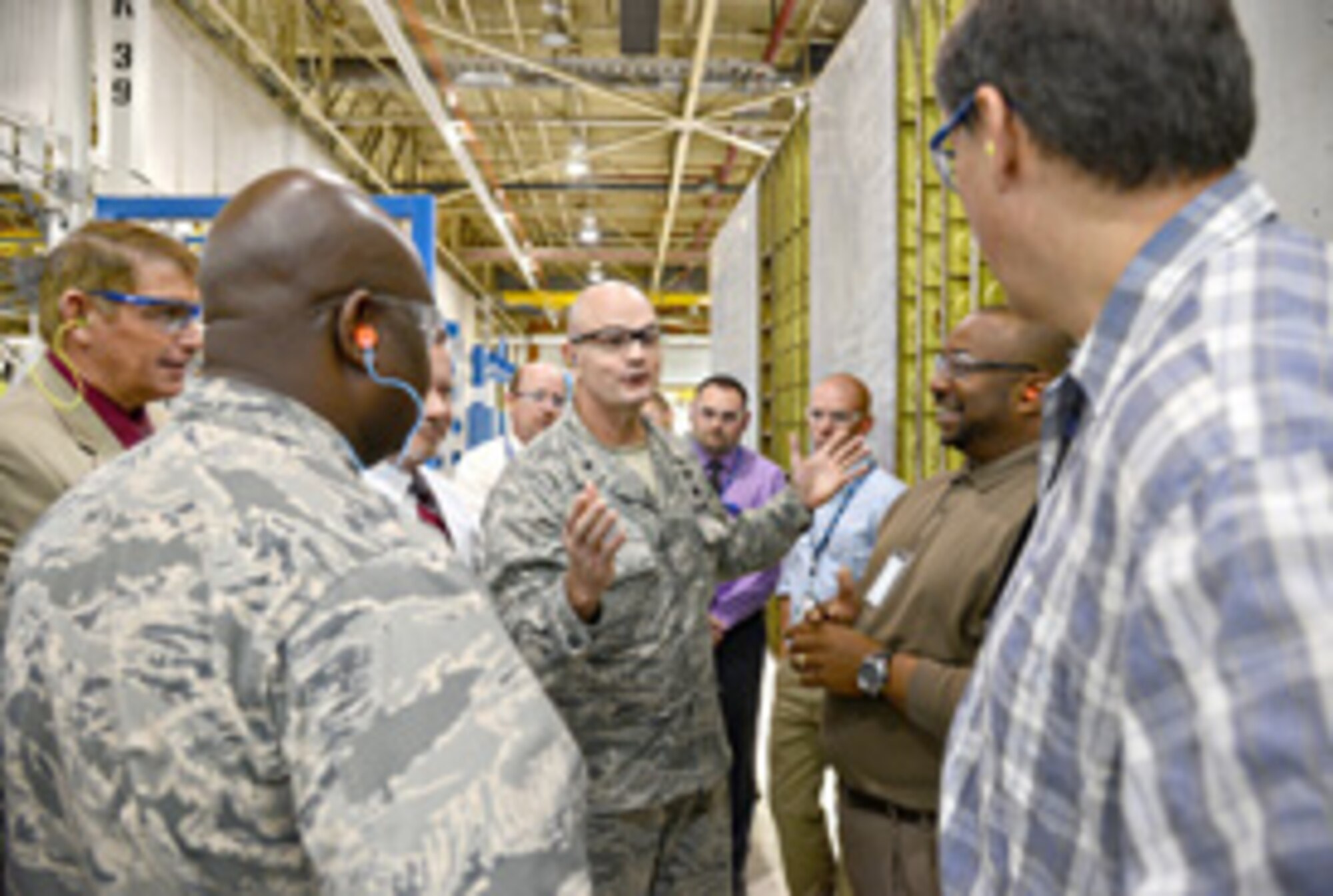 Defense Logistics Agency Aviation Commander Brig. Gen. Allan Day, center, speaks with members of the 76th Commodities Maintenance Group during his Oct. 6 visit to Tinker. During this portion of his tour, General Day visited the B-52 Flap Production line to learn more about the background and future plans for DLA’s support for the shop. With the general are, from left, Mike Mowles, 76th CMXG deputy director; Col. Robert Jackson, 76th CMXG commander; David Carnes, DLA director of engineering; Darrel Anderson, 551st Commodities Maintenance Squadron director; Donald Ticer, 551st CMMXS flight chief; Darin Reeves, mechanical engineer with the 76th CMXG; Donovan Moore, 424th Supply Chain Management Squadron engineering structures flight chief; and Hallie Peltier, 424th SCMS section chief and aerospace engineer. Air Force photo by Kelly White/Released