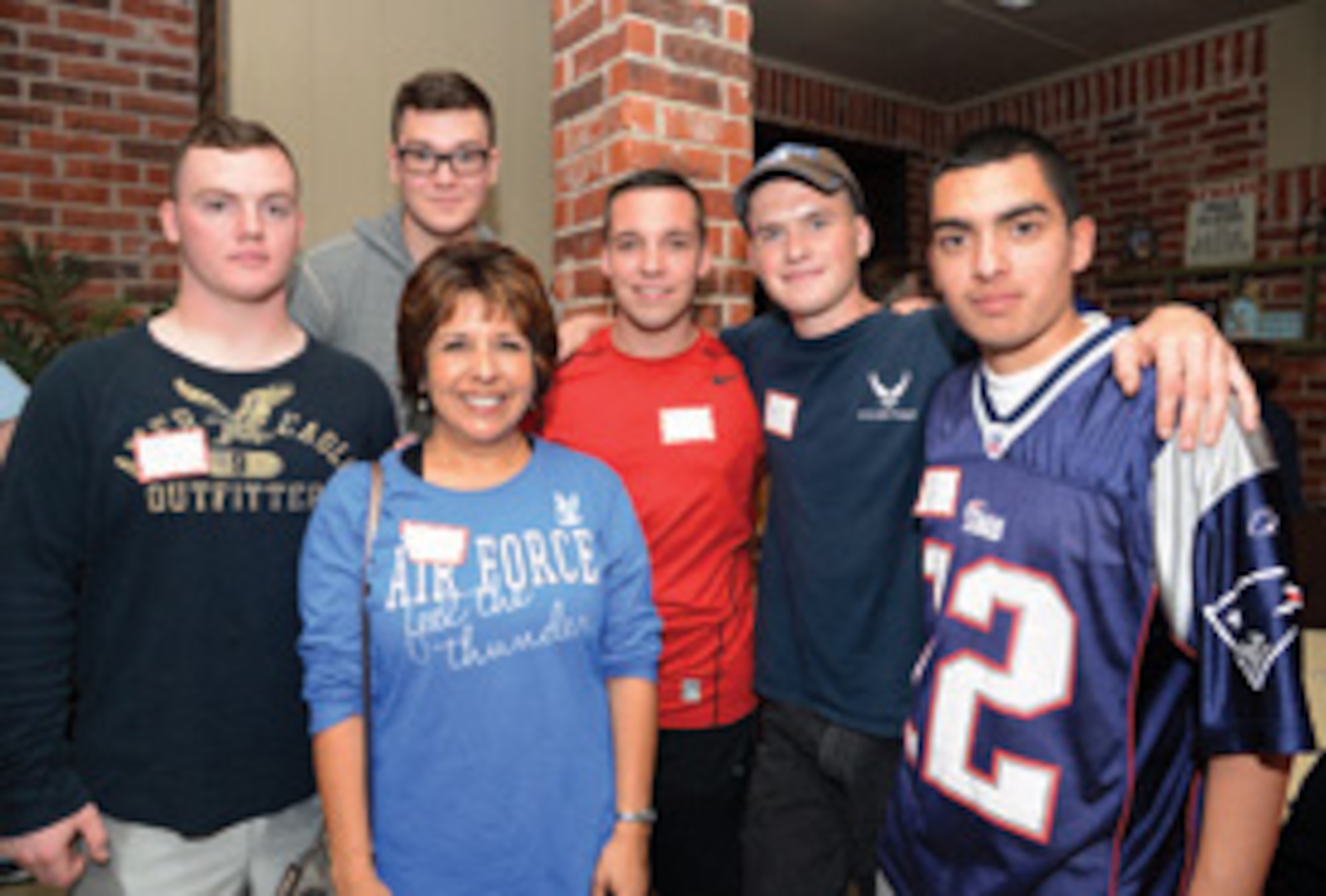 Maria Baker, a host mother with the Home Away From Home program, poses for a picture at a recent picnic for the program with her “adopted” Airmen, left to right, Amn. Basic Nolan Switanowski, Amn. First Class Braden McGee, Amn. First Class Benjamin Pohl, Amn. First Class Kyle Long and Amn. First Class Jacob Lozano. All Airmen are with the 552nd Air Control Wing. Air force photo by Kelly White/Released