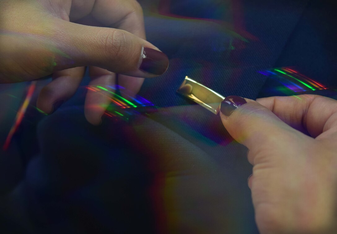 A second lieutenant’s gold-colored bar is placed upon an Air National Guardsmen's service dress jacket Oct. 22, 2015, at Horsham Air Guard Station, Pennsylvania. Air National Guard members go to Maxwell Air Force Base, Alabama, for Officer Training School. (U.S. Air National Guard photo illustration by Master Sgt. Christopher Botzum/Released)