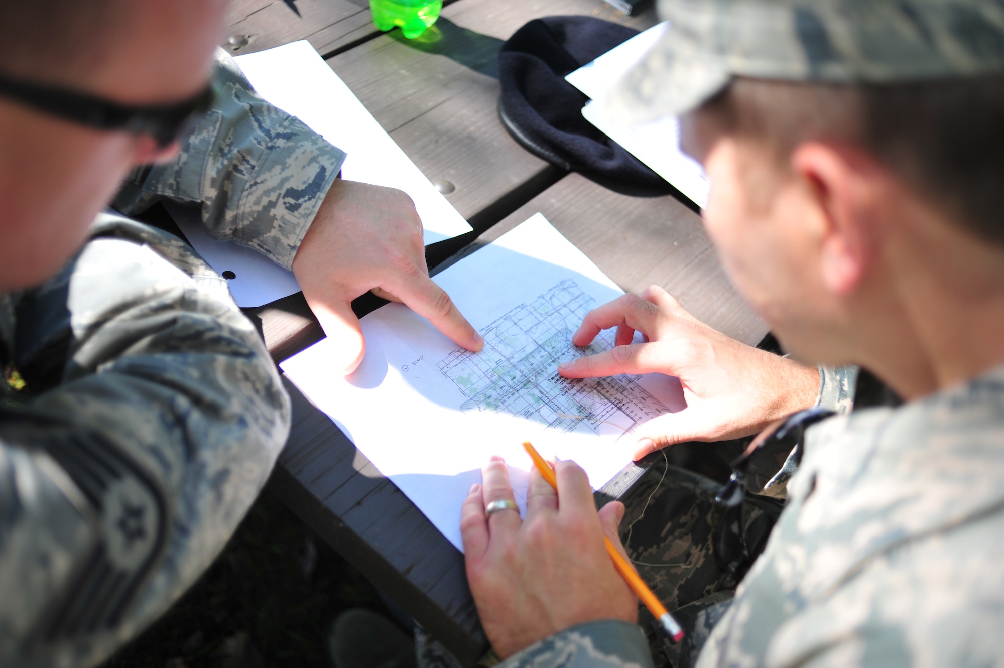 Security Forces Airmen of the 180th Fighter Wing prepare to start a land navigation course by examining a map grid at Oak Openings Metro Park in Swanton, Ohio on Sep. 27, 2015. The 180th Security Forces Squadron used old-school navigations tools, such as a compass and map, to maneuver a training course that prepares Airmen for scenarios when advanced technology may fail and leave them to rely only on the most basic resources. (Ohio Air National Guard photo by Staff Sgt. John Wilkes)