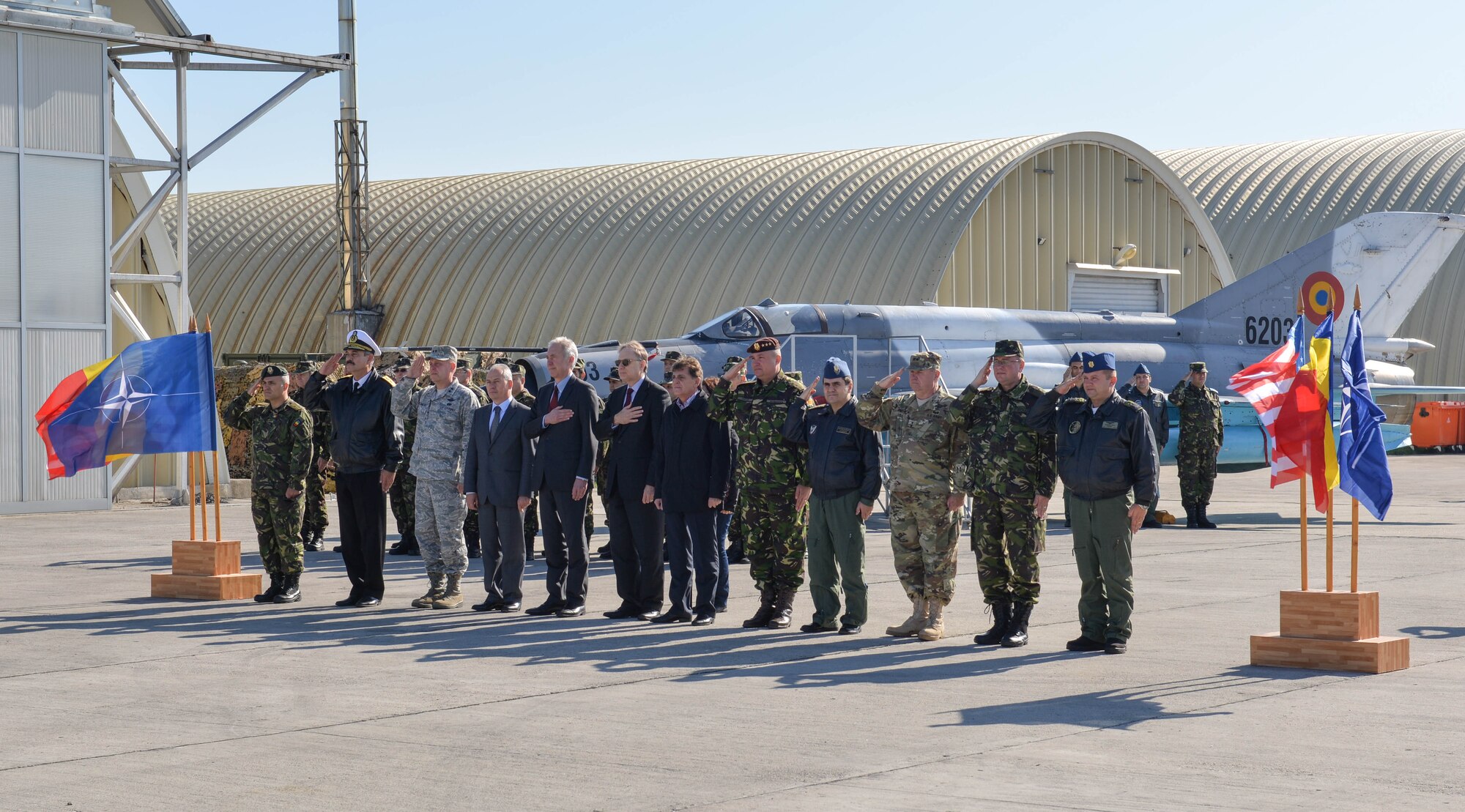 Senior leaders from the U.S. and Romania salute during the playing of the American and Romanian anthems during the opening remarks at the exercise Dacian Viper DV day at Campia Turzii, Romania, Oct. 16, 2015. Exercise Dacian Viper is a flying training deployment between the Alabama Air National Guard and Romanian Air Force designed to increase readiness to conduct combined air operations and to meet future security challenges. (U.S. Air Force photo by Capt. Lauren Ott/Released)