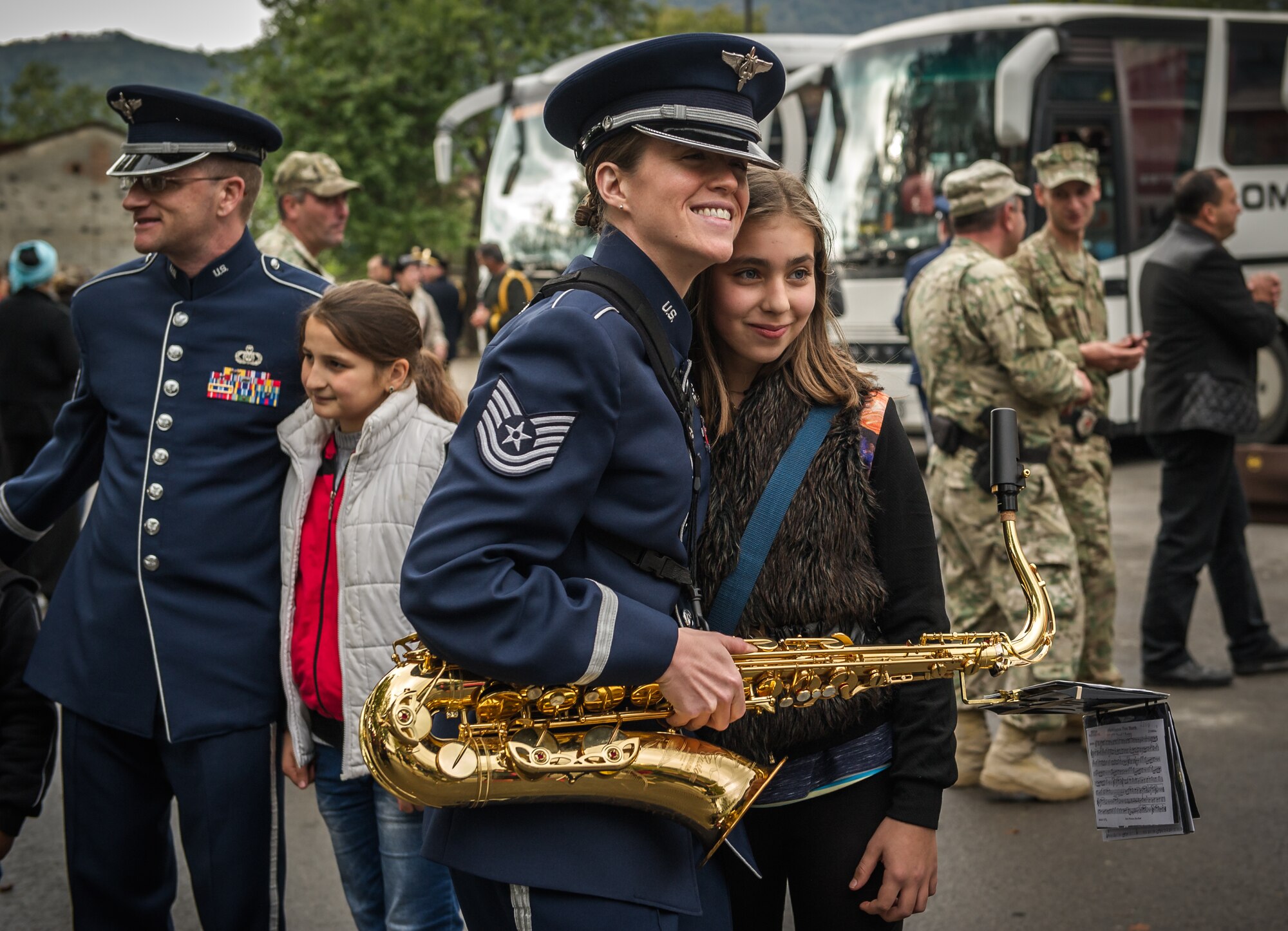 Tech. Sgt. Chantelle Friedman, U.S. Air Forces in Europe Band saxaphone player, poses for a photo with a Georgian girl after a marching band performance in Kvareli, Georgia, Oct. 18, 2015. From Oct. 15-19, 33 bandsmen from the U.S. Air Forces in Europe Band traveled to the Republic of Georgia for several events including performing in the First International Military Bands Festival in Tbilisi. This is the first time in nearly 10 years that the USAFE Band has traveled to conduct a mission in the Republic of Georgia. Georgia and the U.S. are proven military partners and engagements like these help to further strengthen the bonds between our two nations. (U.S. Air Force photo/ Tech. Sgt. Ryan Crane)