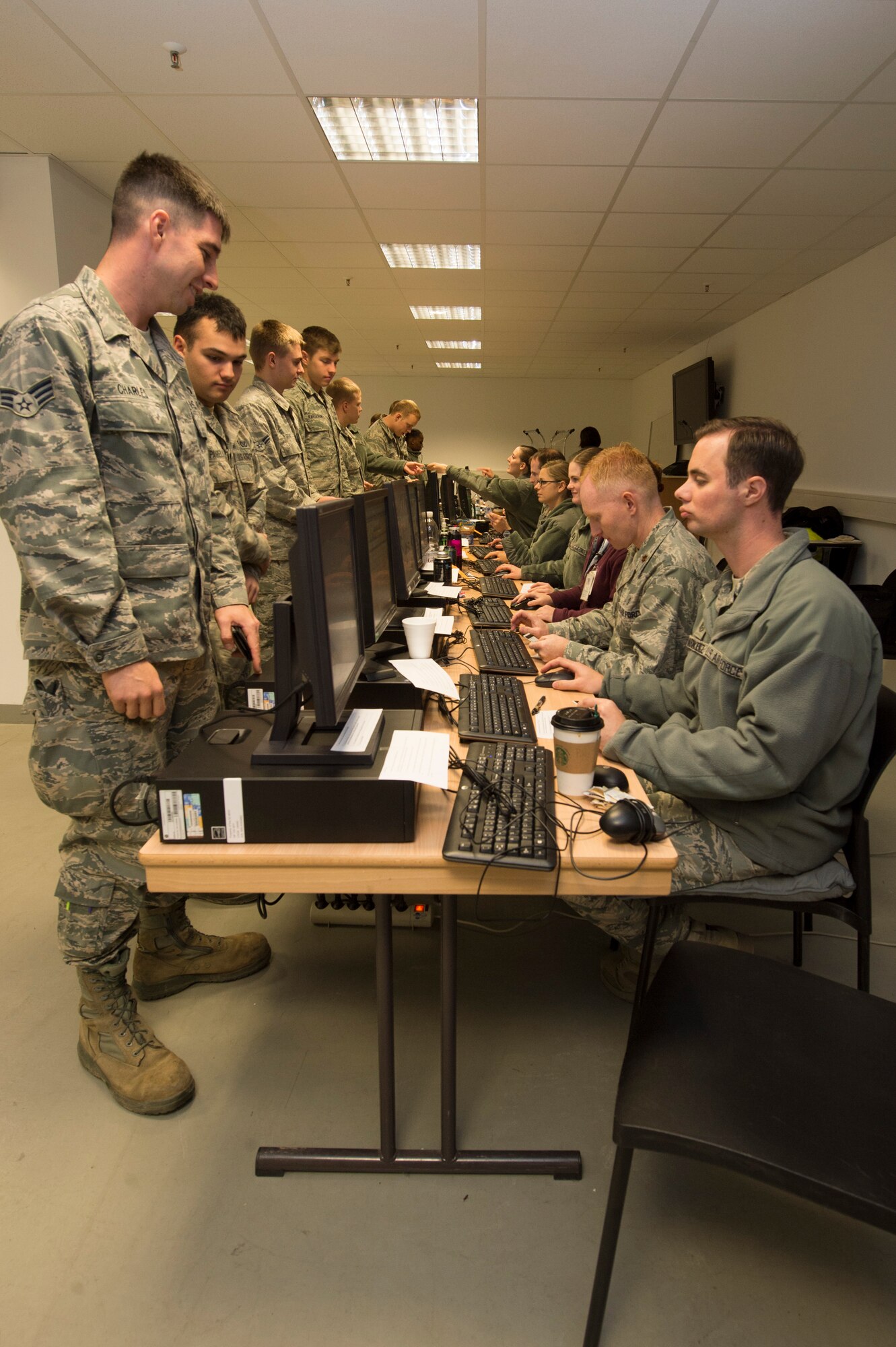 Airmen have their medical records updated before receiving the influenza vaccine during a disease containment plan exercise Oct. 21, 2015, at Spangdahlem Air Base, Germany. The mass vaccination demonstrated the wing’s capability to protect the base population in the event of a disease threat or outbreak. (U.S. Air Force photo by Staff Sgt. Christopher Ruano/Released)