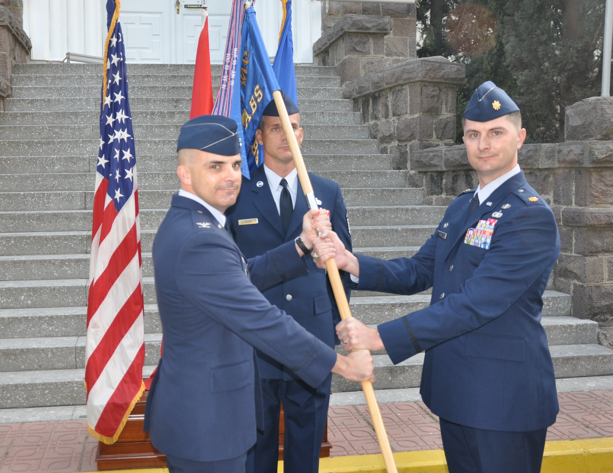 Maj. Timothy Cook, right, assumes command of the 425th Air Base Squadron from Col. Russell Voce, 39th Mission Support Group commander,  Oct. 20, 2015, at Izmir Air Station, Turkey. The 425th ABS performs as administrative agent and provides mission support for the NATO Allied Land Command Headquarters, Izmir, as well as six other associate units. (U.S. Air Force photo by Tanju Varlikli/Released)