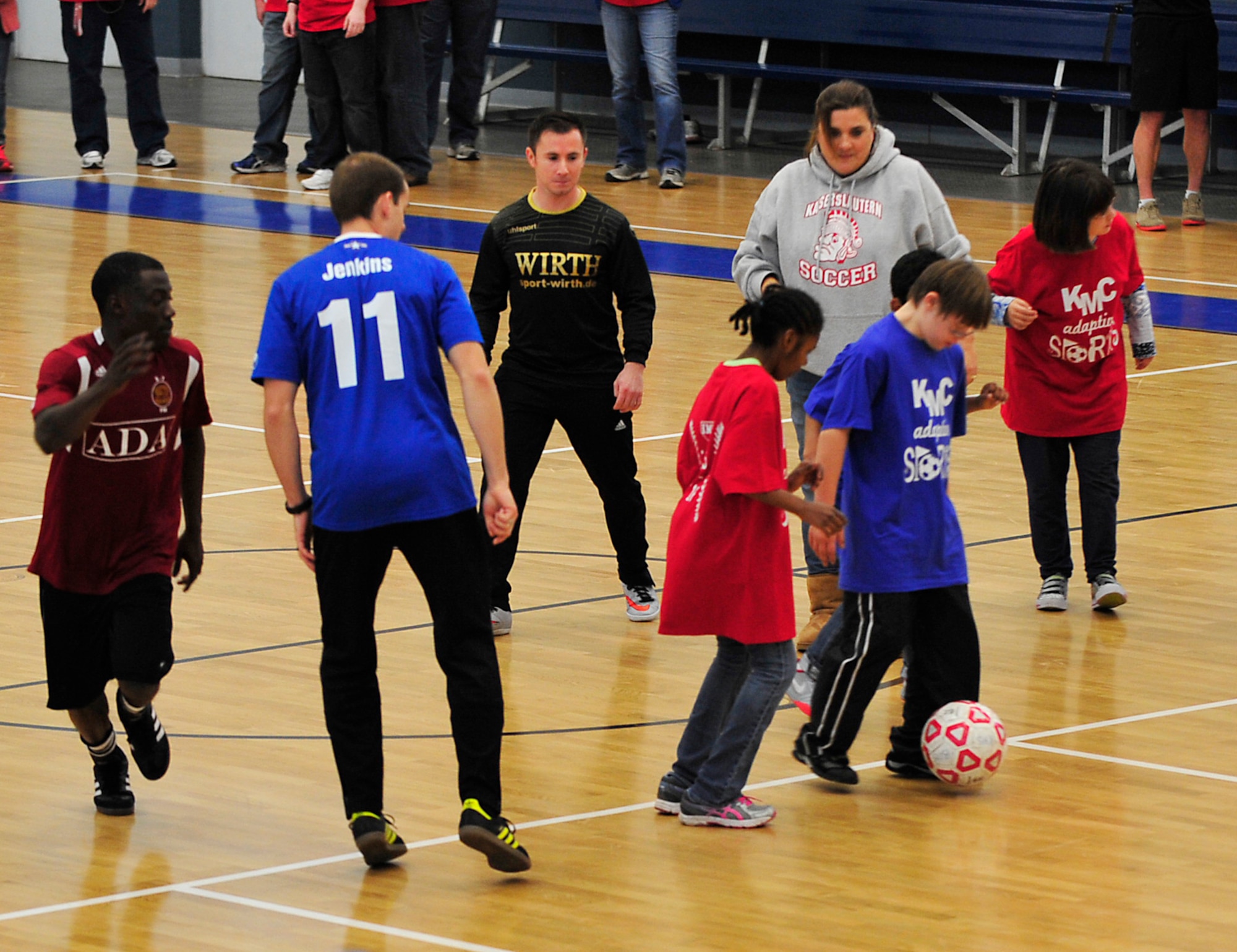 Students from Ramstein and Vogelweh Middle and High schools compete in a soccer match during the Kaiserslautern Military Community Adaptive Sports soccer event Oct. 15, 2015, at Vogelweh Military Complex, Germany. The Adaptive Sports are a series of events to include basketball and softball which provide students with special needs the opportunity to participate in healthy activities. (U.S. Air Force photo/Airman 1st Class Larissa Greatwood)