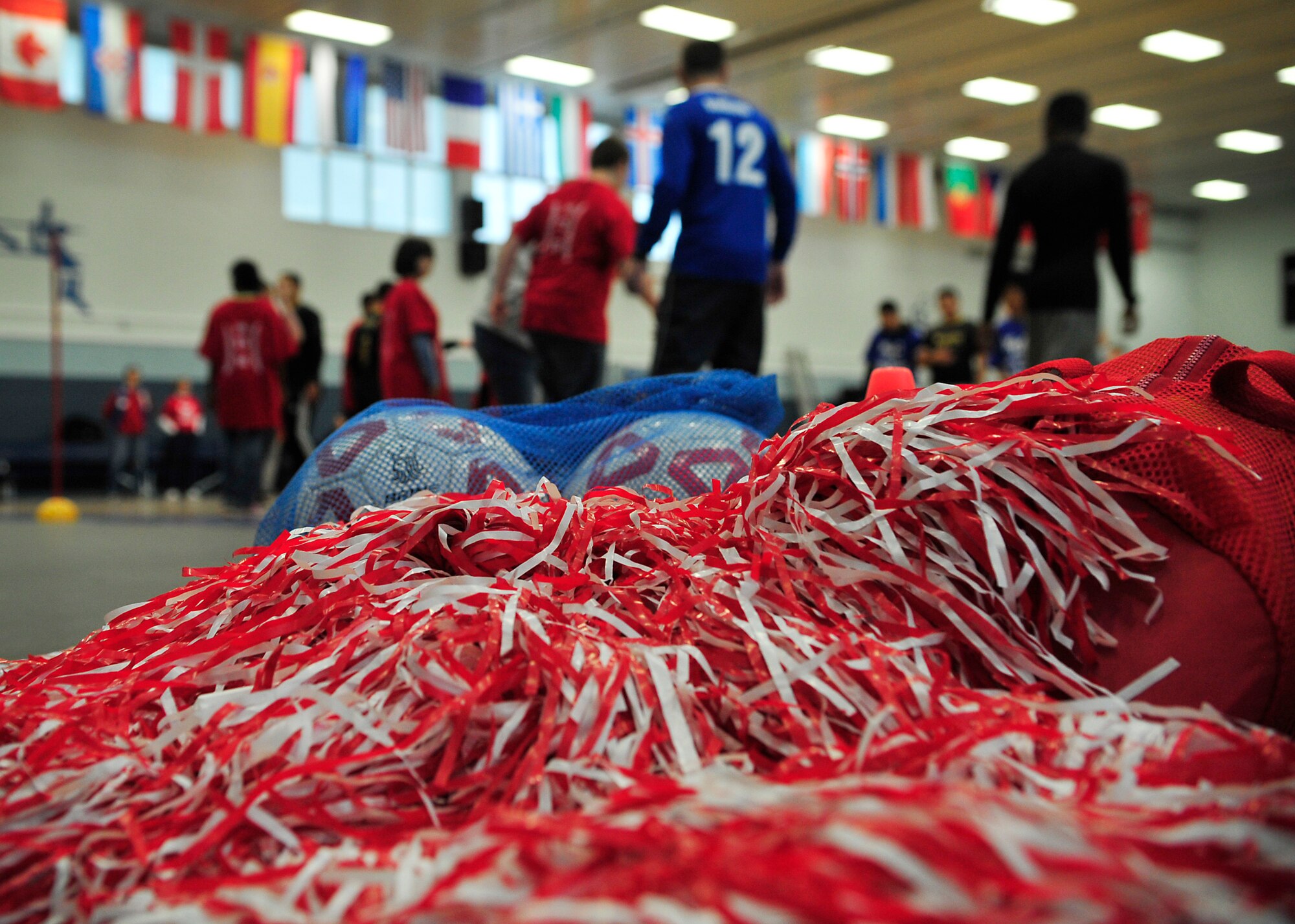 Soccer equipment and pompoms lie on the floor during the Kaiserslautern Military Community Adaptive Sports soccer event Oct. 15, 2015, at Vogelweh Military Complex, Germany. Students from Ramstein and Vogelweh Middle and High Schools came together for a friendly soccer competition to build camaraderie and morale. (U.S. Air Force photo/Airman 1st Class Larissa Greatwood)
