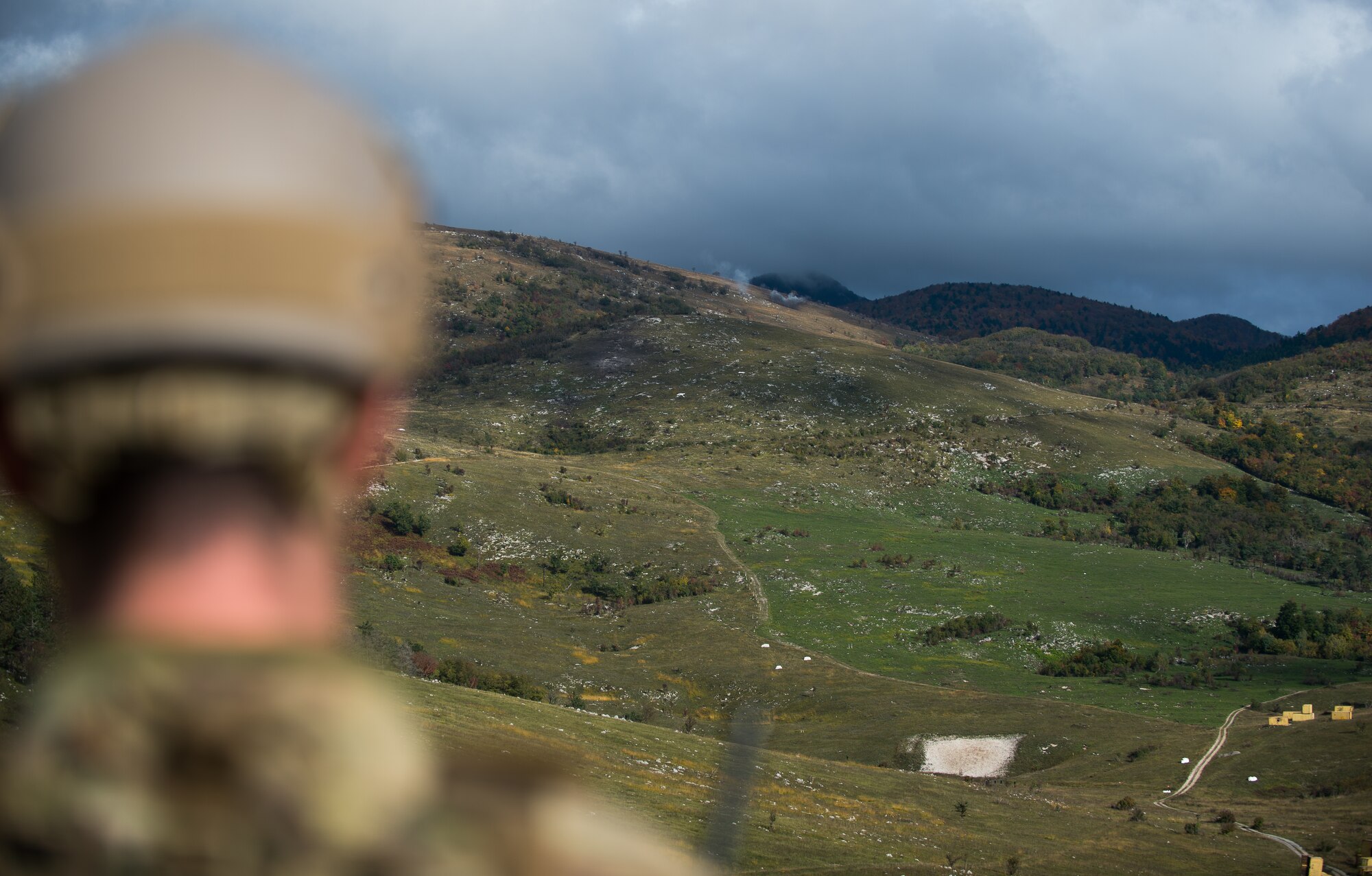 U.S. Air Force Senior Airman Gage Duvall, 2nd Air Support Operations Squadron joint terminal attack controller in training, watches artillery rounds land during Rock Proof V Oct. 16, 2015, at Pocek Training Range, near Postojna, Slovenia. Rock Proof is a U.S. Army multilateral exercise designed to improve interoperability between U.S and Slovenian militaries. (U.S. Air Force photo/Staff Sgt. Armando A. Schwier-Morales) 