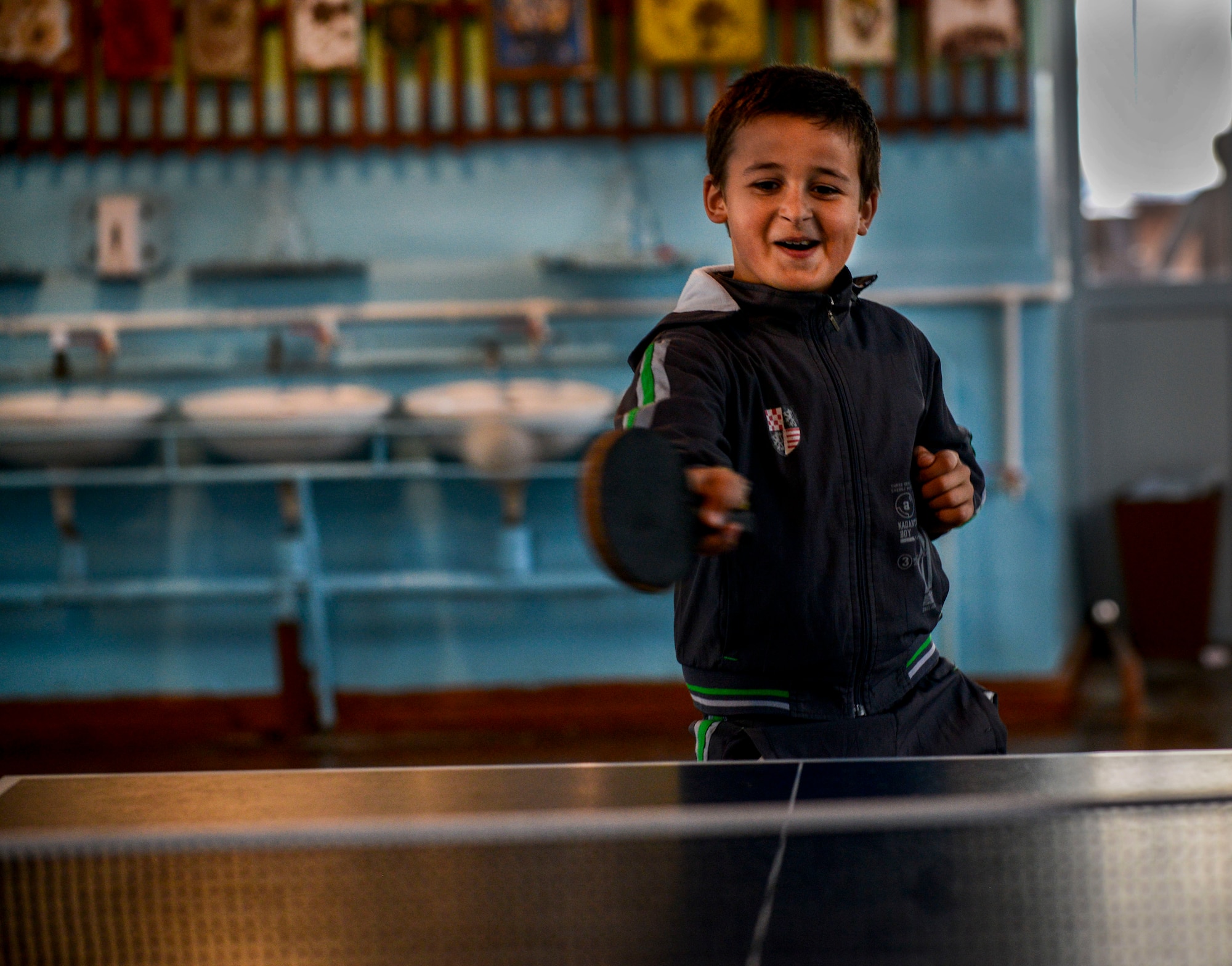 A Moldovan student plays ping-pong Oct. 19, 2015, at Liceul Teoretic Alexei Mateevici School, Sanatauca, Moldova. Approximately seven Airmen from the 435th Construction and Training Squadron and the 52nd Civil Engineer Squadron worked on the renovations since Sept. 23. The renovations were part of the Moldova Humanitarian and Civic Assistance program is part of a military and civilian theater security cooperation program the U.S. European Command uses to directly impact civilian communities throughout 17 countries, primarily in Eastern Europe. (U.S. Air Force photo/Senior Airman Nicole Sikorski)