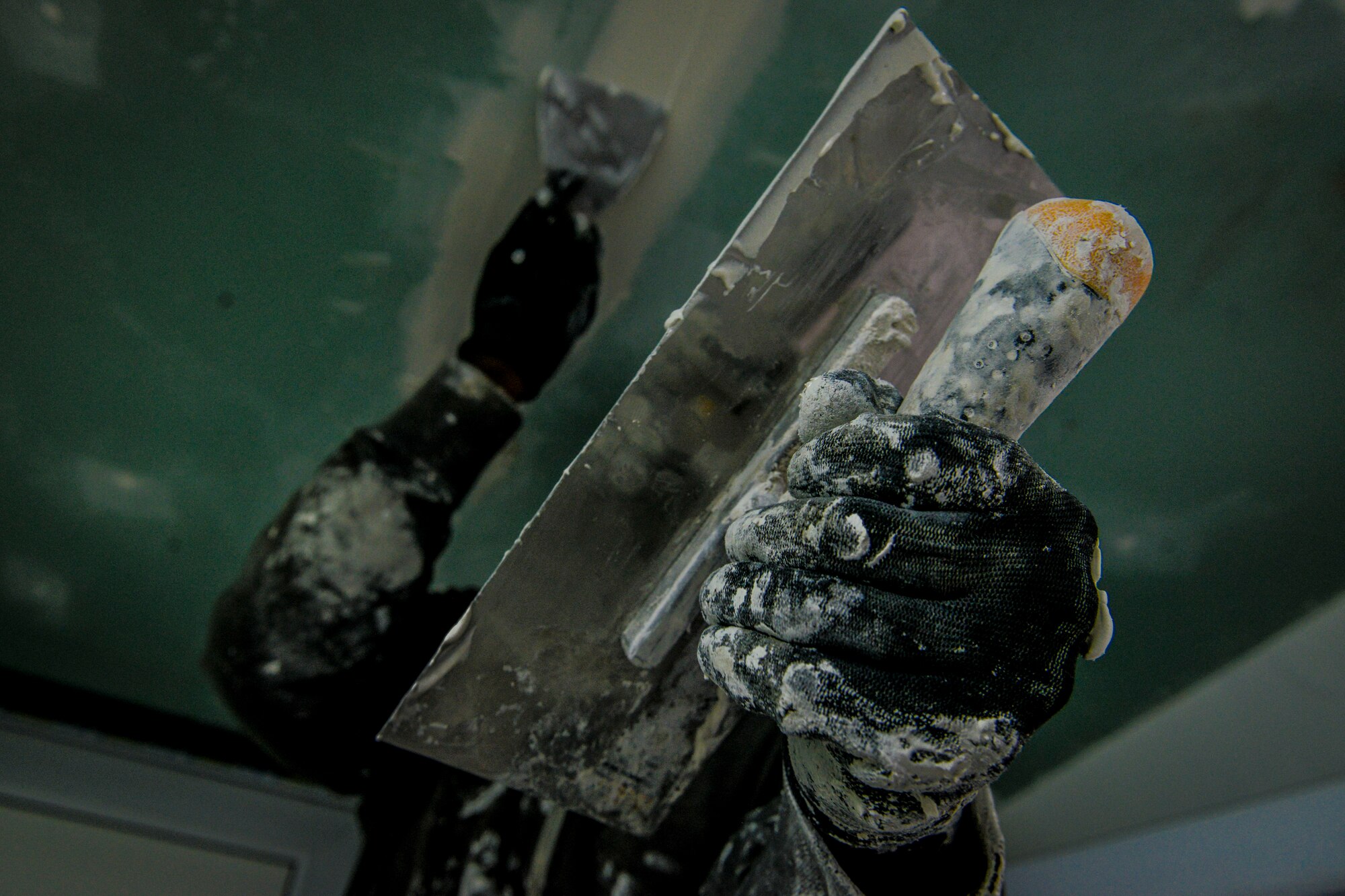 Staff Sgt. Altes Durand, 435th Construction and Training Squadron NCO in charge of heating, cool, ventilation and air conditioning, applies spackle paste to a ceiling Oct. 18, 2015, at Liceul Teoretic Alexei Mateevici School, Sanatauca, Moldova. Approximately seven Airmen from the 435th CTS and the 52nd Civil Engineer Squadron worked on the renovations since Sept. 23. The renovations were part of the Moldova Humanitarian and Civic Assistance program is part of a military and civilian theater security cooperation program the U.S. European Command uses to directly impact civilian communities throughout 17 countries, primarily in Eastern Europe.(U.S. Air Force photo/Senior Airman Nicole Sikorski)