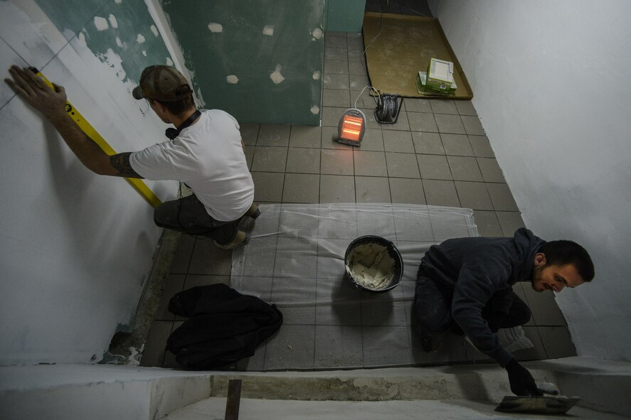 Senior Airman Bradley Cain and Staff Sgt. Dorsey Sirmans, both 435th Construction and Training Squadron structural craftsmen, renovate a locker room Oct. 18, 2015, at Liceul Teoretic Alexei Mateevici School, Sanatauca, Moldova.  Approximately seven Airmen from the 435th CTS and the 52nd Civil Engineer Squadron have been working on the renovations since Sept. 23. The Moldova Humanitarian and Civic Assistance program is part of a military and civilian theater security cooperation program the U.S. European Command uses to directly impact civilian communities throughout 17 countries, primarily in Eastern Europe. As well as allowing service members the opportunity to further their skillsets on the construction site, HCA projects also promote increased bonds and trust for future operations and improvement between the U.S. and partnered nations. (U.S. Air Force photo/Senior Airman Nicole Sikorski)