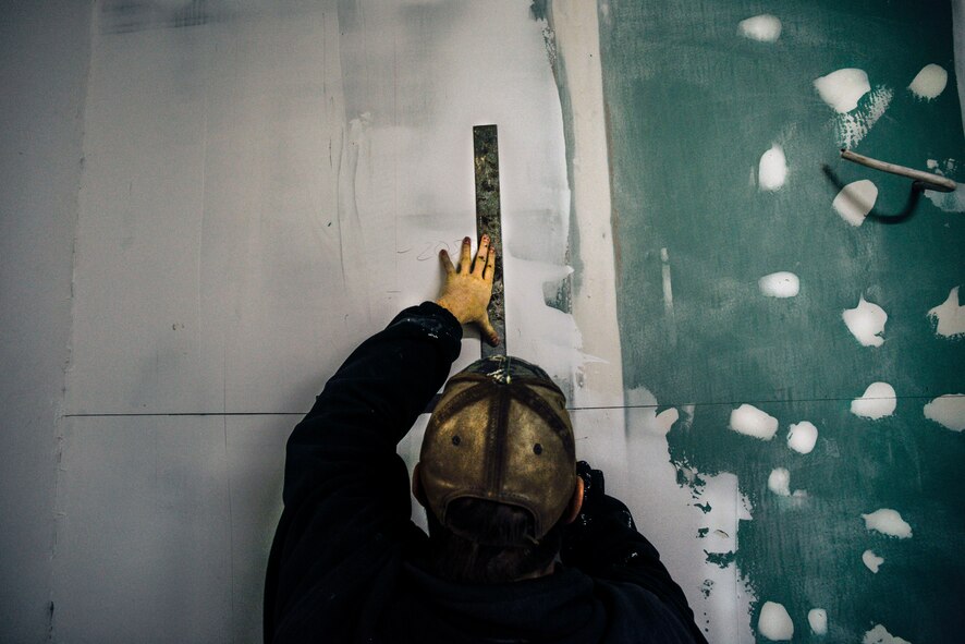 Senior Airman Bradley Cain, 435th Construction and Training Squadron structural craftsman, marks a wall as part of renovations to a locker room Oct. 18, 2015, at Liceul Teoretic Alexei Mateevici School, Sanatauca, Moldova.  Approximately seven Airmen from the 435th CTS and the 52nd Civil Engineer Squadron have been working on the renovations since Sept. 23. The Moldova Humanitarian and Civic Assistance program is part of a military and civilian theater security cooperation program the U.S. European Command uses to directly impact civilian communities throughout 17 countries, primarily in Eastern Europe.  As well as allowing service members the opportunity to further their skillsets on the construction site, HCA projects also promote increased bonds and trust for future operations and improvement between the U.S. and partnered nations. (U.S. Air Force photo/Senior Airman Nicole Sikorski)