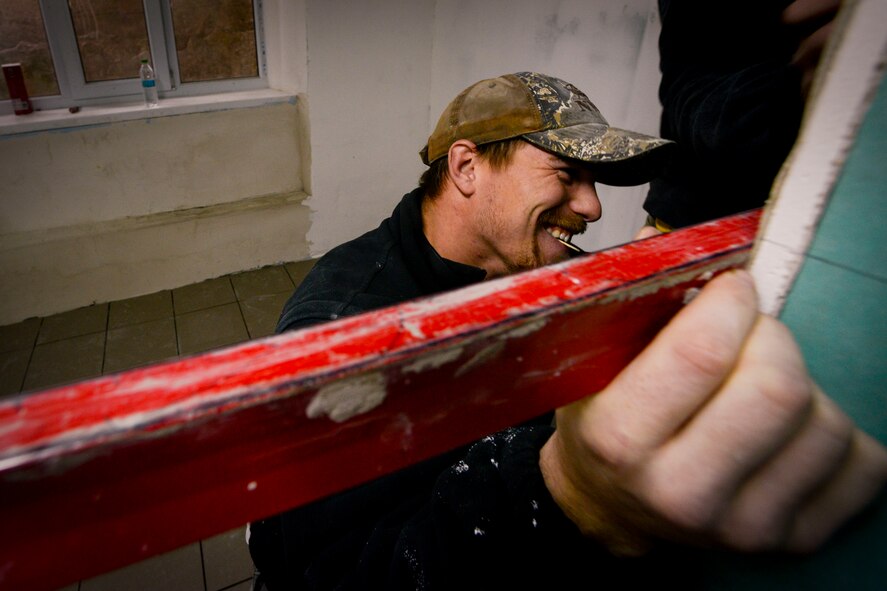 Senior Airman Bradley Cain, 435th Construction and Training Squadron structural craftsman, helps remodel a gym locker room Oct. 18, 2015, at Liceul Teoretic Alexei Mateevici School, Sanatauca, Moldova.  Approximately seven Airmen from the 435th CTS and the 52nd Civil Engineer Squadron worked on the renovations since Sept. 23. The renovations were part of the Moldova Humanitarian and Civic Assistance program is part of a military and civilian theater security cooperation program the U.S. European Command uses to directly impact civilian communities throughout 17 countries, primarily in Eastern Europe.  (U.S. Air Force photo/Senior Airman Nicole Sikorski) 