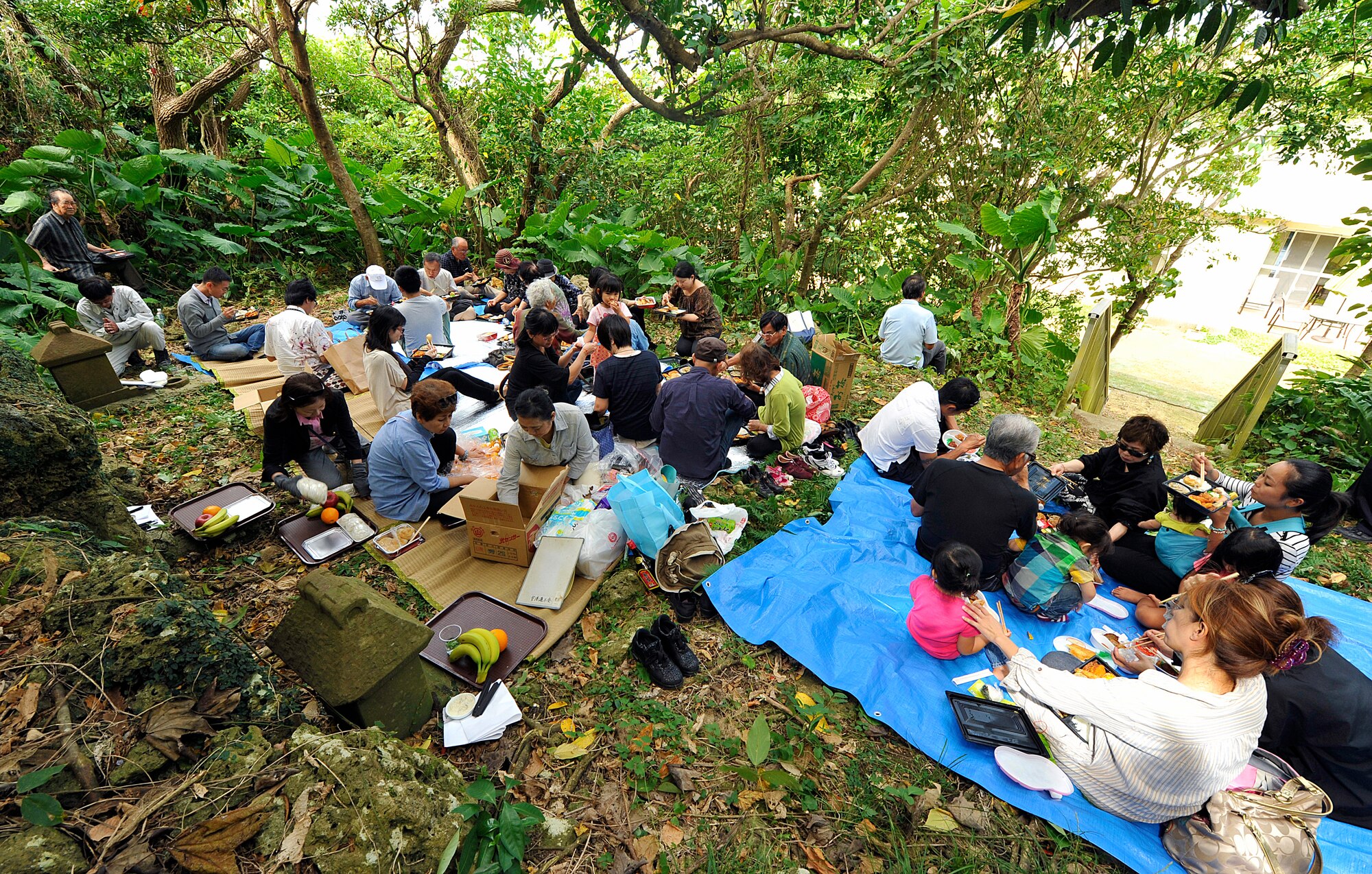 Local Okinawans gather in front of tombs for ceremonial meals at the Morine Bijiru during the annual sacred sites visit Oct. 21, 2015, on Kadena Air Base, Japan. Okinawans are often sponsored onto the base so they can visit sites of historical, religious and ancestral significance and to learn about significant pieces of history here on Kadena.  (U.S. Air Force photo by Naoto Anazawa)