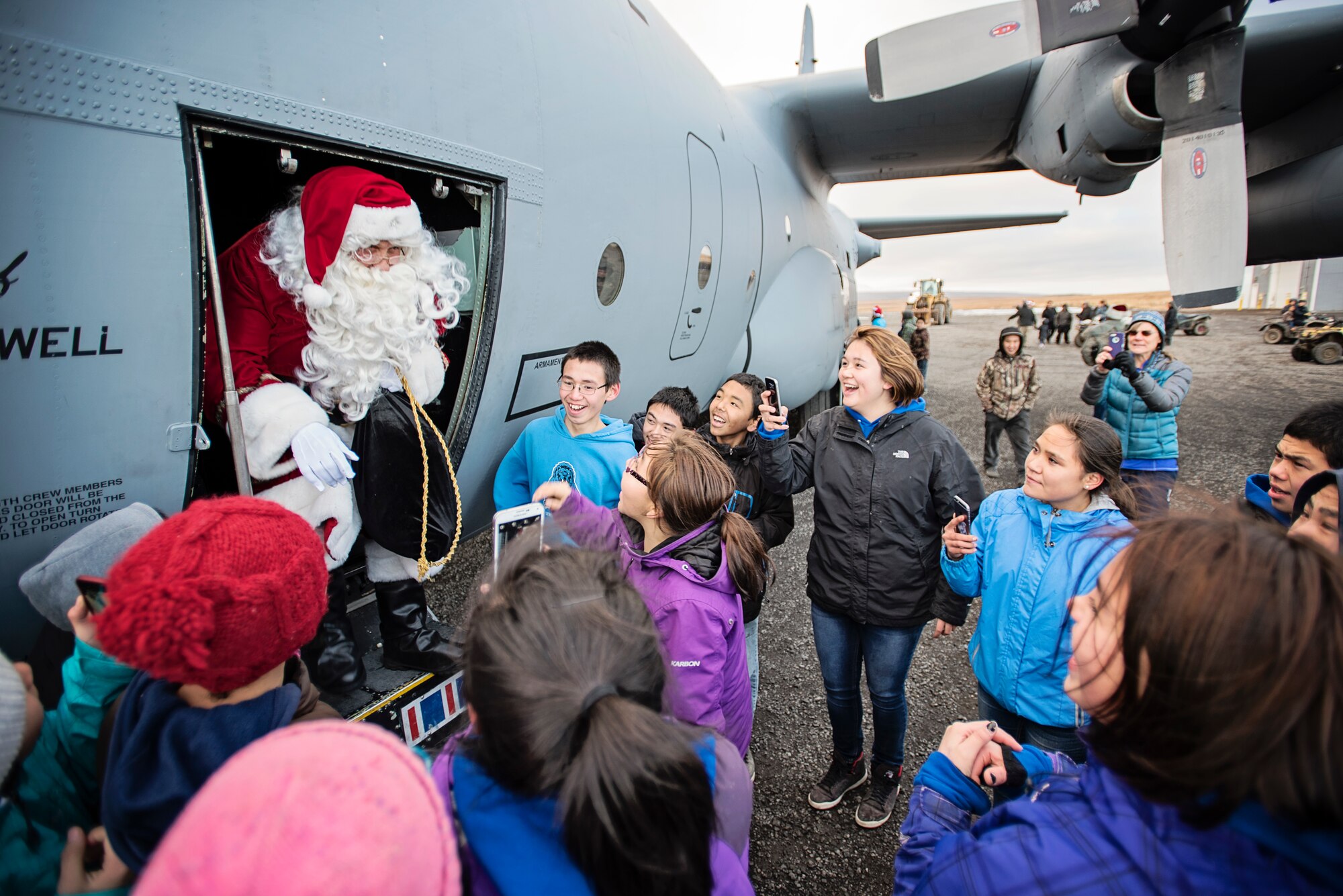 JOINT BASE ELMENDORF-RICHARDSON, Alaska -- Children in Savoonga, Alaska, greet Santa Claus as he emerges from a C-130 Hercules aircraft from the 144th Airlift Squadron, Alaska Air National Guard, Oct. 16, during this year's Operation Santa mission. This year marks the 59th year of the program, which serves to bring Christmas to underserved, remote villages across Alaska each year. (U.S. National Guard photo by Staff Sgt. Edward Eagerton)