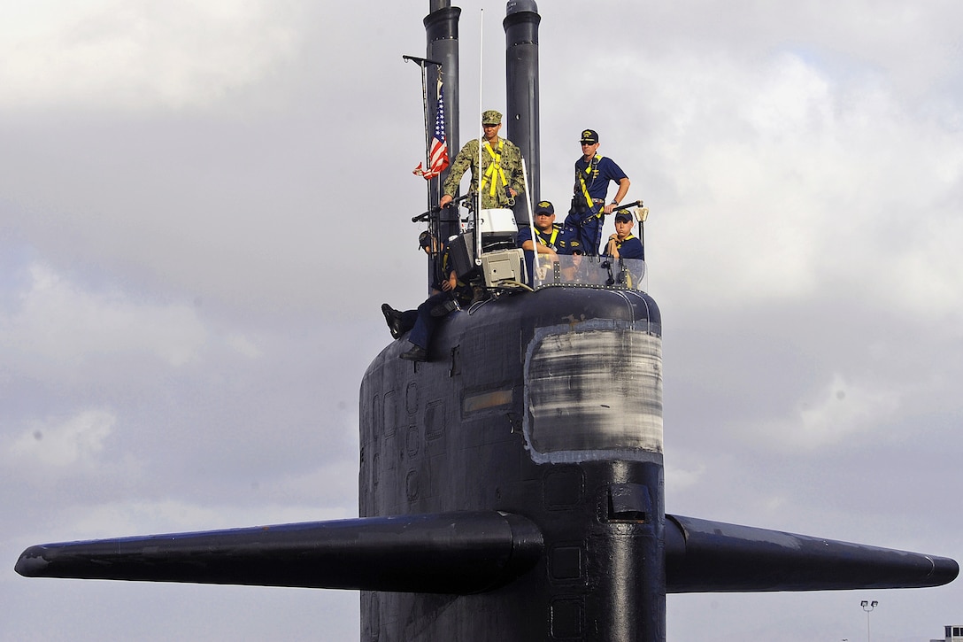 Navy Cmdr. Donald Tenney, right, commanding officer of the Los Angeles-class fast-attack submarine USS Albuquerque, stands on the bridge as the submarine prepares to depart San Diego for the final time, Oct. 21, 2015. An inactivation ceremony on Naval Base Point Loma marked more than 32 years of Naval service. Albuquerque is en route to Puget Sound Naval Shipyard in Bremerton, Wash., to begin inactivation and eventual decommissioning. U.S. Navy photo by Petty Officer 2nd Class Kyle Carlstrom
