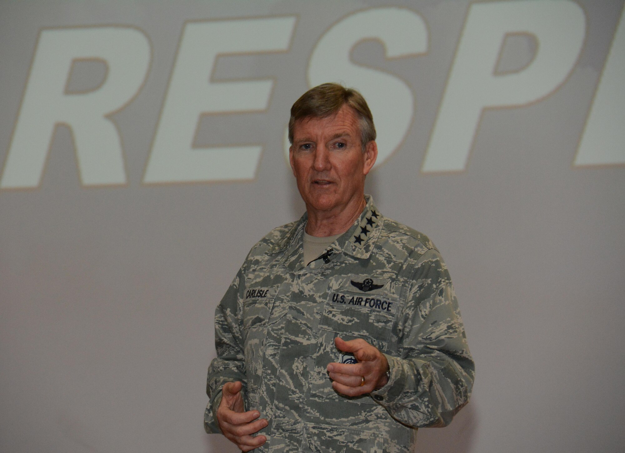 U.S. Air Force Gen. Hawk Carlisle, commander of Air Combat Command, shares his perspective on respect with more than 300 members of Al Udeid Air Base, Qatar during an all-call event at the Coalition Compound Theater Oct. 21, 2015. During the all-call, Carlisle also stressed the importance of being innovative and resilient and thanked every service member for their dedication to the mission. (U.S. Air Force photo by Tech. Sgt. James Hodgman/Released)