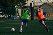 Members from the U.S. and Republic of Korea air forces participate in a soccer game during the Korean and American Friendship Day at Kunsan Air Base, Republic of Korea, Oct. 23, 2015. They participated in activities throughout the day to celebrate and strengthen the partnership shared by the ROK and U.S. (U.S. Air Force photo by Senior Airman Ashley L. Gardner/Released) 